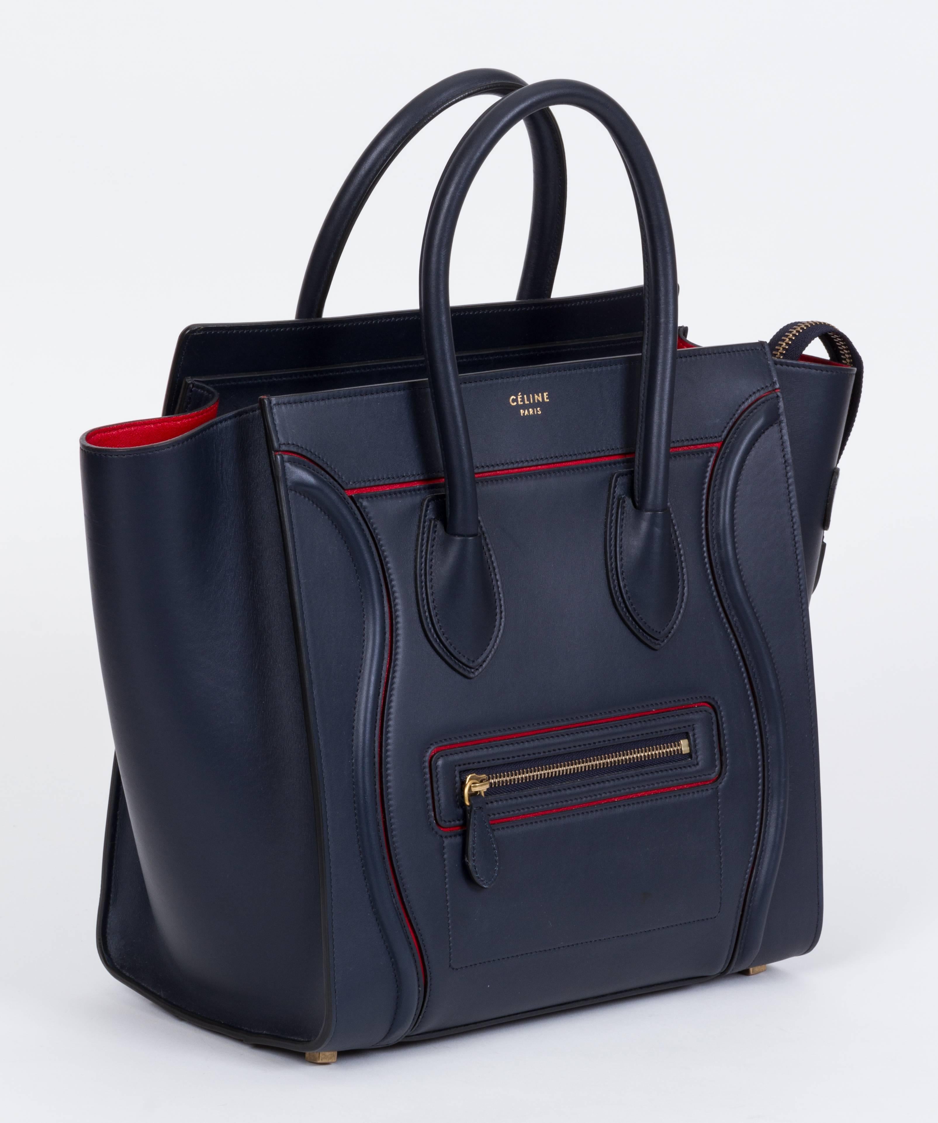 Celine Paris limited edition mini luggage bag. Navy blue leather and red Carmen interior. Collection 2015/2016. Made in Italy by one artisan, 25 pieces of leather stitched together. Interior zipped compartment, two interior pouches, outside zipped