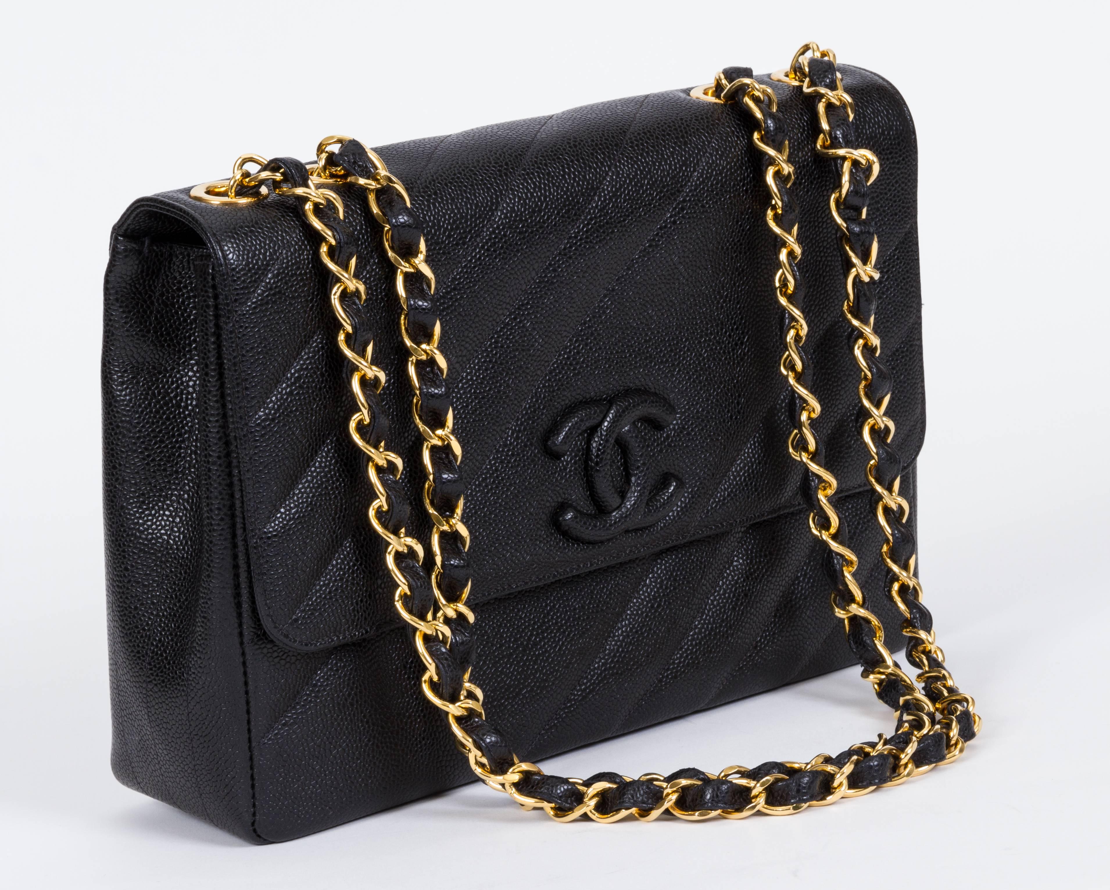 Chanel black caviar leather diagonal quilted jumbo single flap. Excellent condition. Collection 1994/1996. Comes with hologram, ID card, booklet, dust cover. Measurements: 12