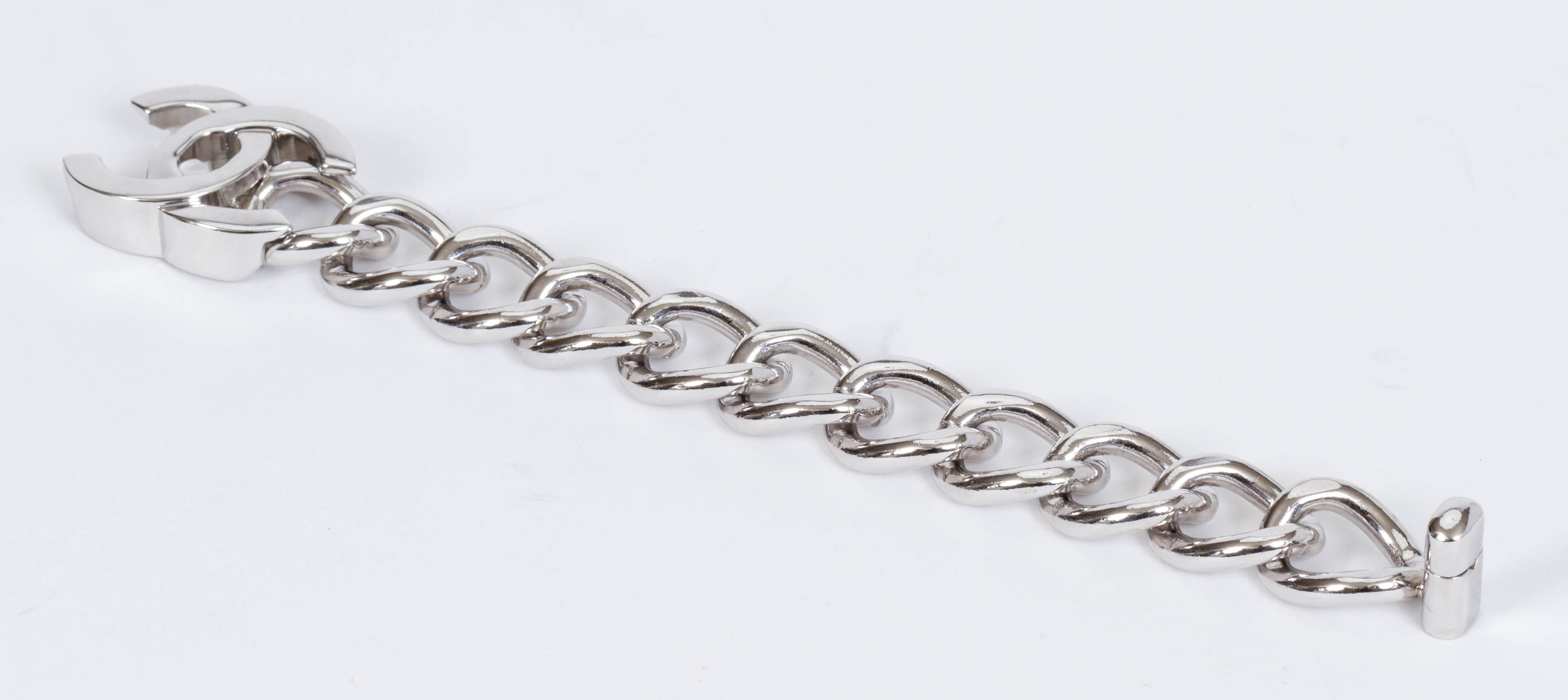 Chanel silver color turn lock bracelet with cc logo clasp. Collection spring 96. Measures 8.25