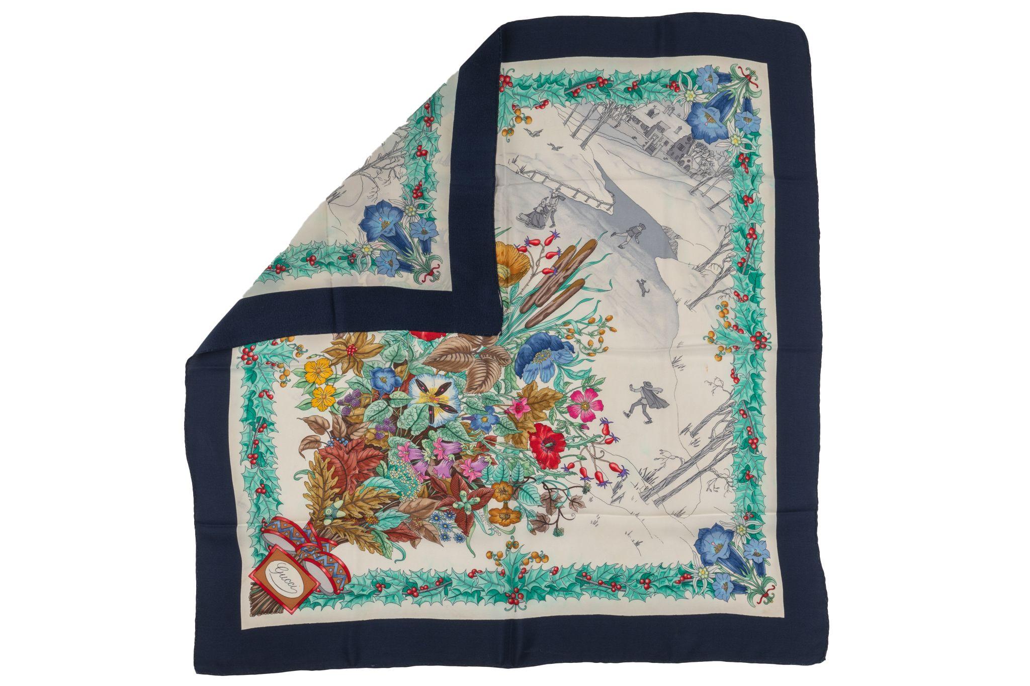 Esta bufanda Gucci vintage de tema invernal diseñada por V. Accornero La bufanda tiene un borde azul marino Presenta flores multicolores, un marco de acebo y una escena de patinaje sobre hielo. Muy coleccionable. 
Sin etiqueta.