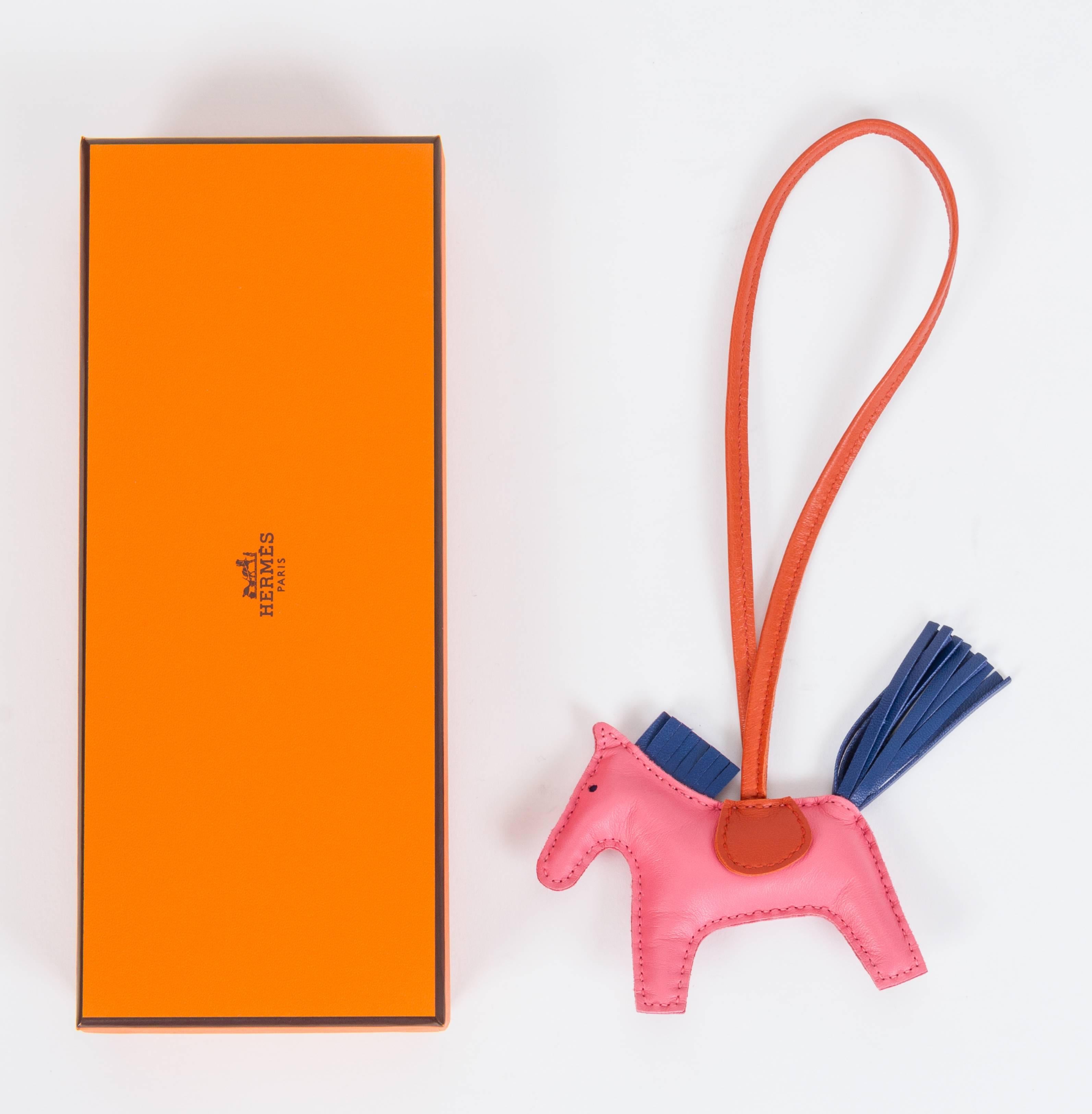 Hermes rare and collectible grigri rodeo bag charm PM (small). Combination of rose azalea, cornelian and blue de malte. Brand new in box with ribbon and gift bag.