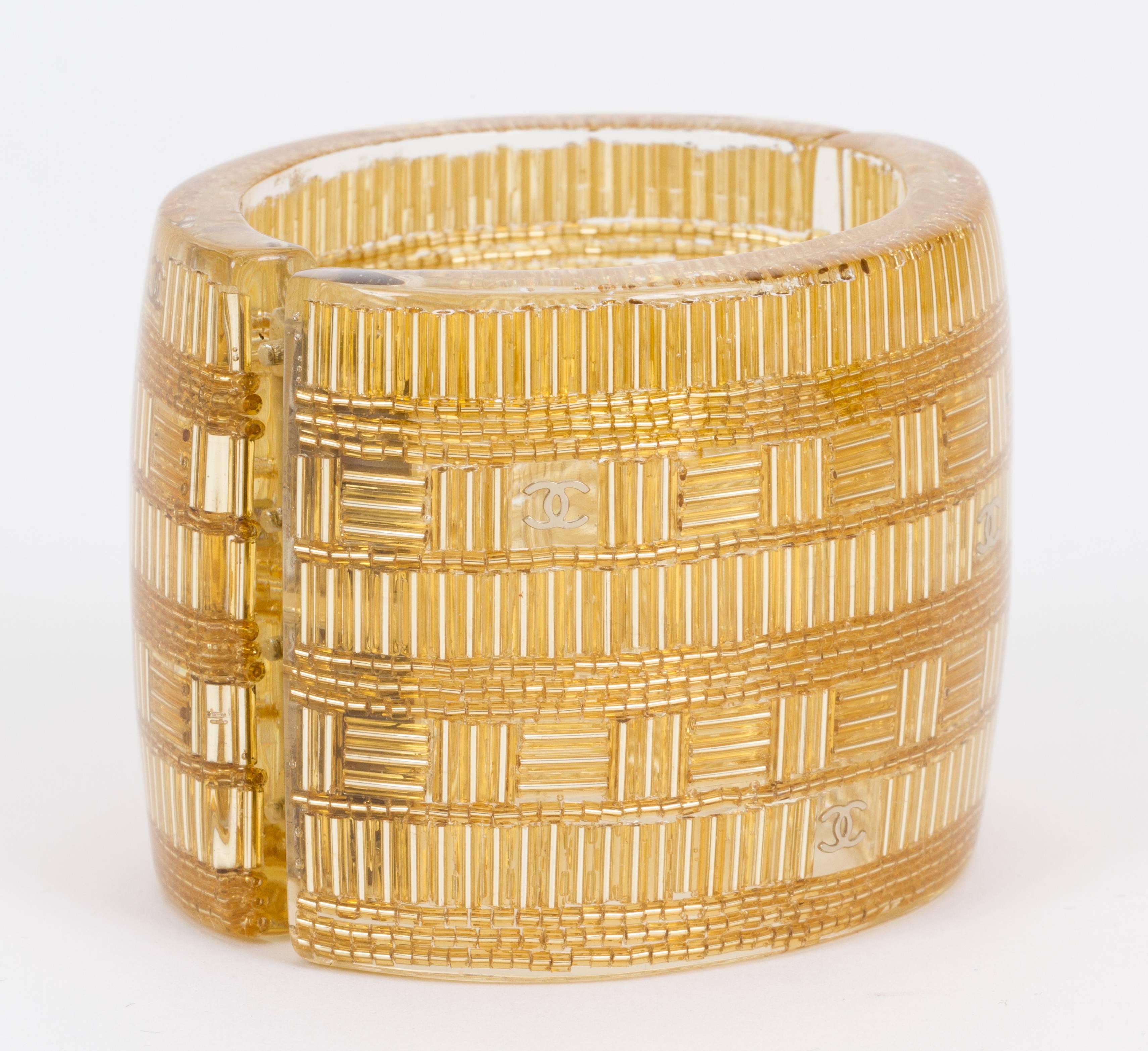 Chanel spring 2015 hinged lucite cuff bracelet. Gold and clear combination. Interior diameter 2 1/4