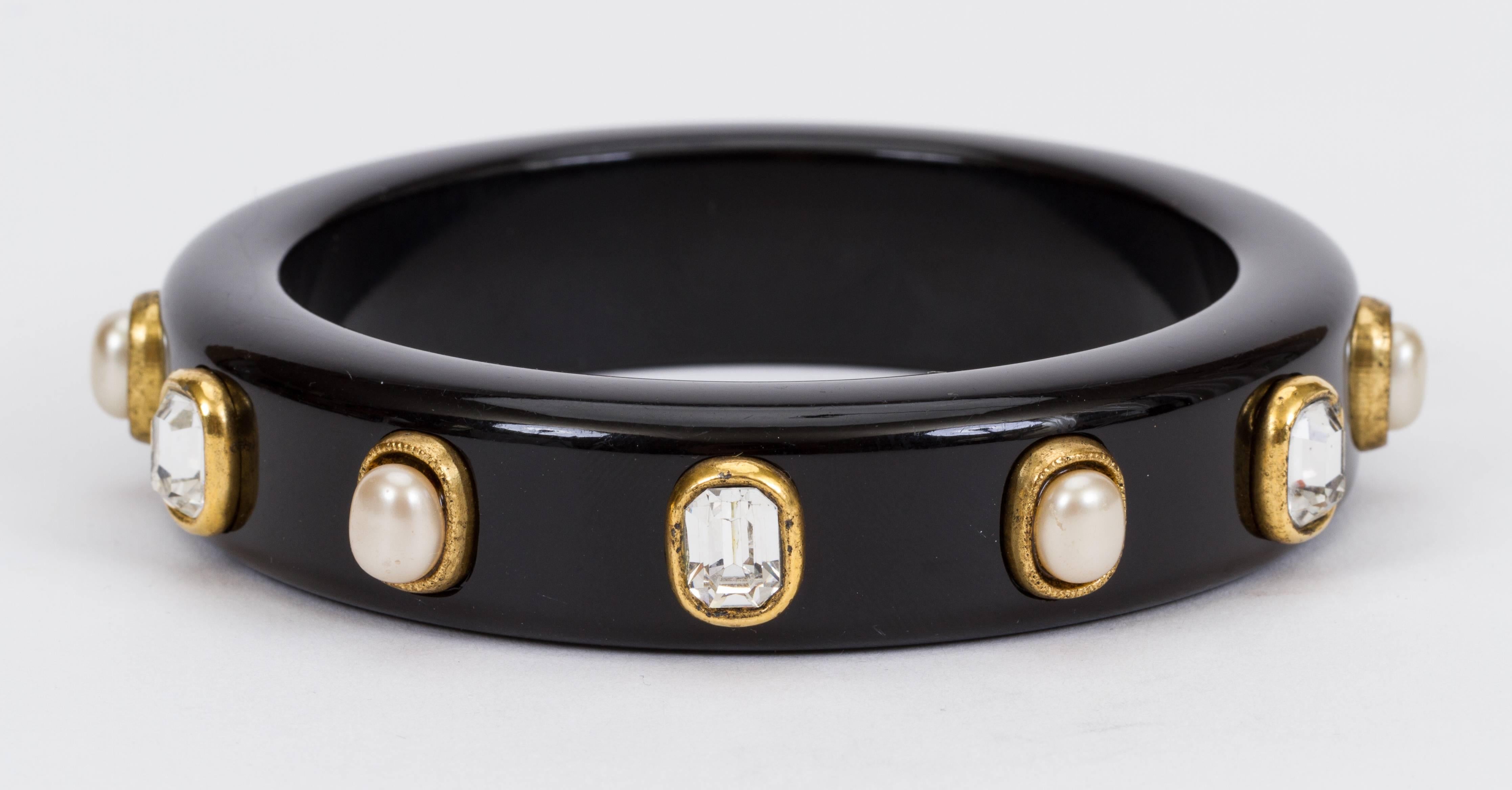 Chanel 70s black resin bangle with crystal and pearl beads. Interior diameter 2.5