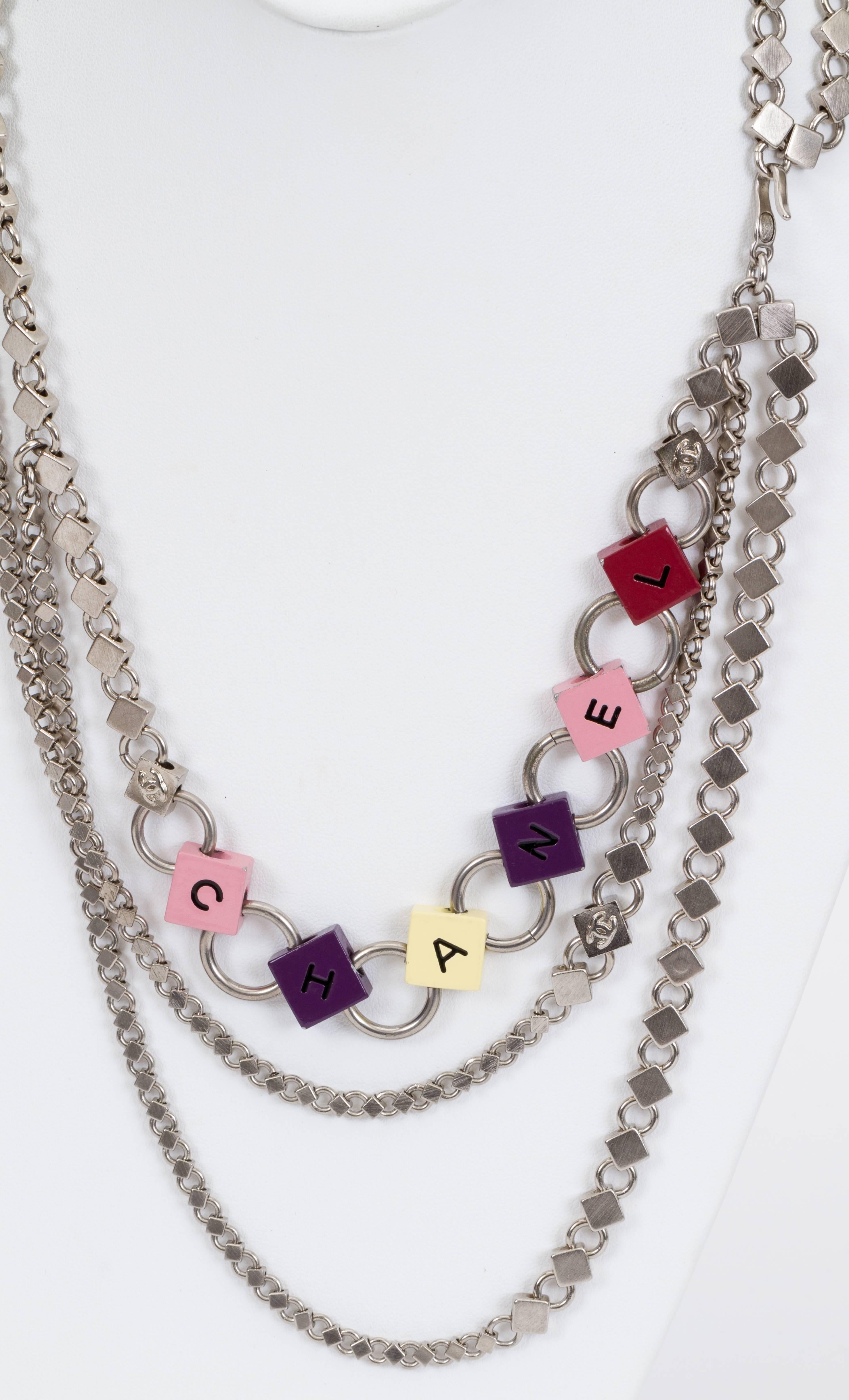 Chanel triple belt /necklace in silver tone brushed metal and multicolor letters. Collection spring 04. Comes with original box.