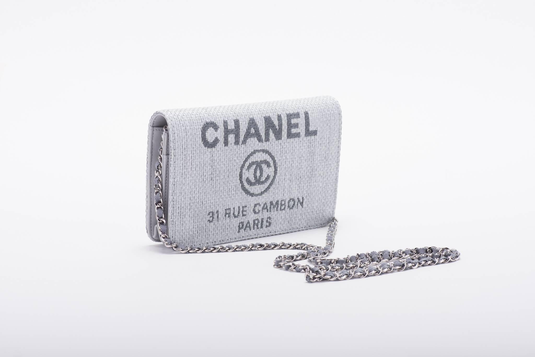Chanel brand new in box cross body wallet on a chain in grey linen and leather. Can be worn also as a clutch. Blue leather interior.  Comes with hologram, ID card, booklet, box and ribbon.