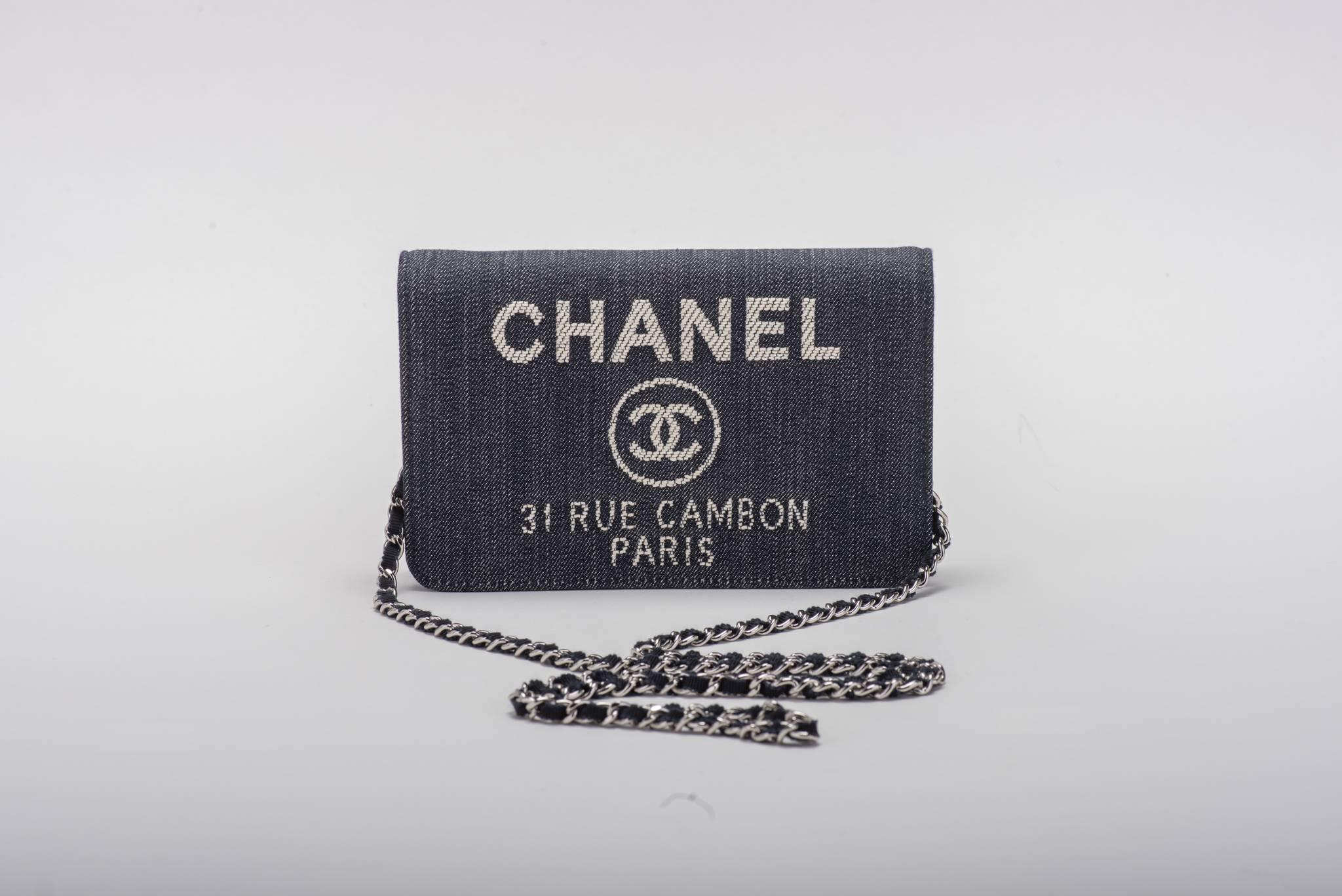 Chanel brand new in box cross body wallet on a chain in blue denim. Can be worn also as a clutch. Blue leather interior.  Comes with hologram, ID card, booklet, box and ribbon.