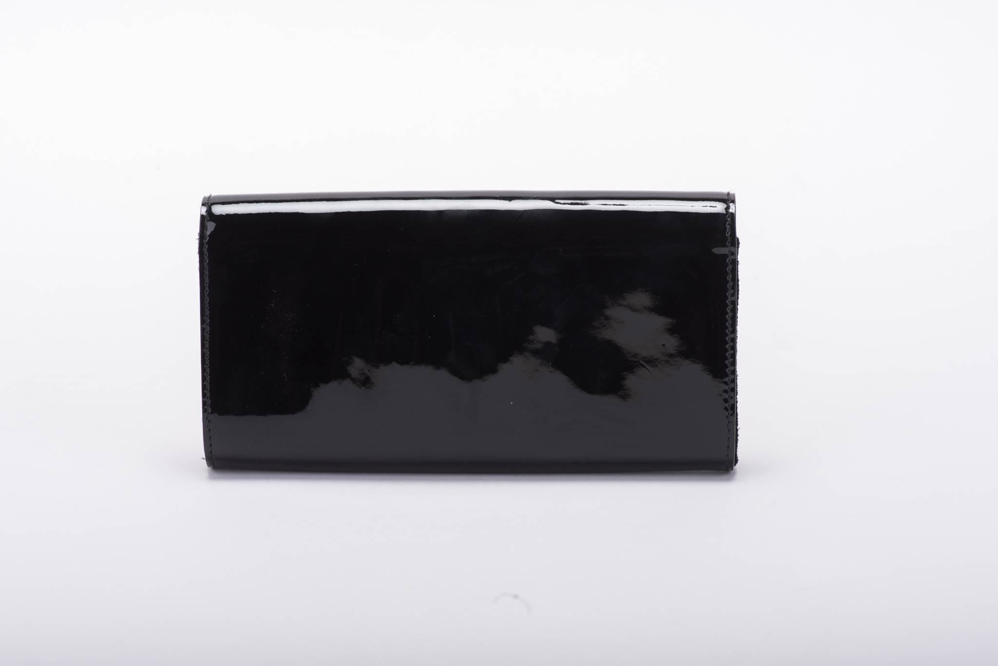 Gucci unworn black patent leather evening clutch with center black gem oversized stone. Brand new with plastic still in the back of clasp. Comes with original dust cover.
