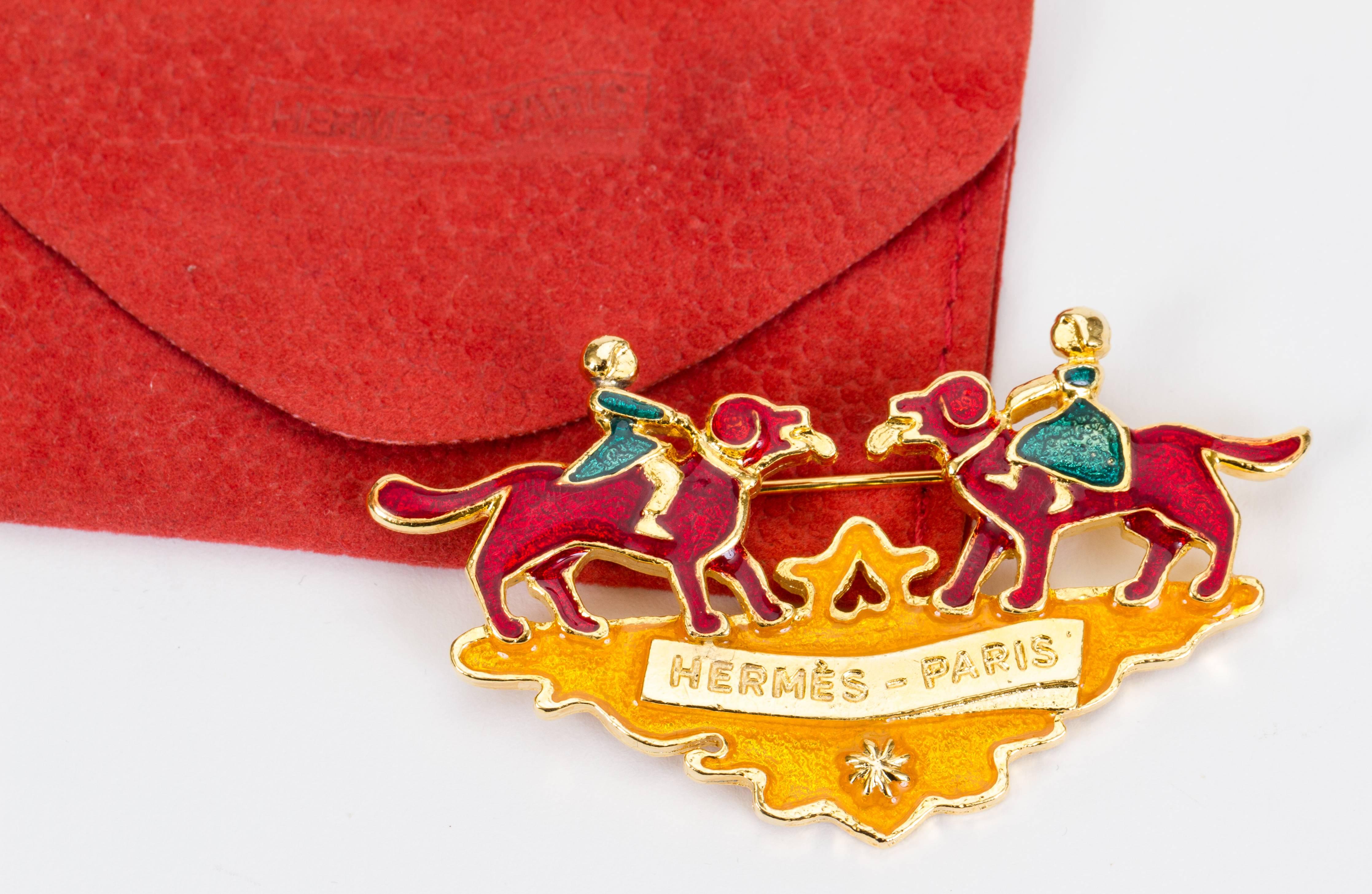Hermes enamel multicolor enamel Christmas pin with gold tone plating. Comes with red suede pouch.