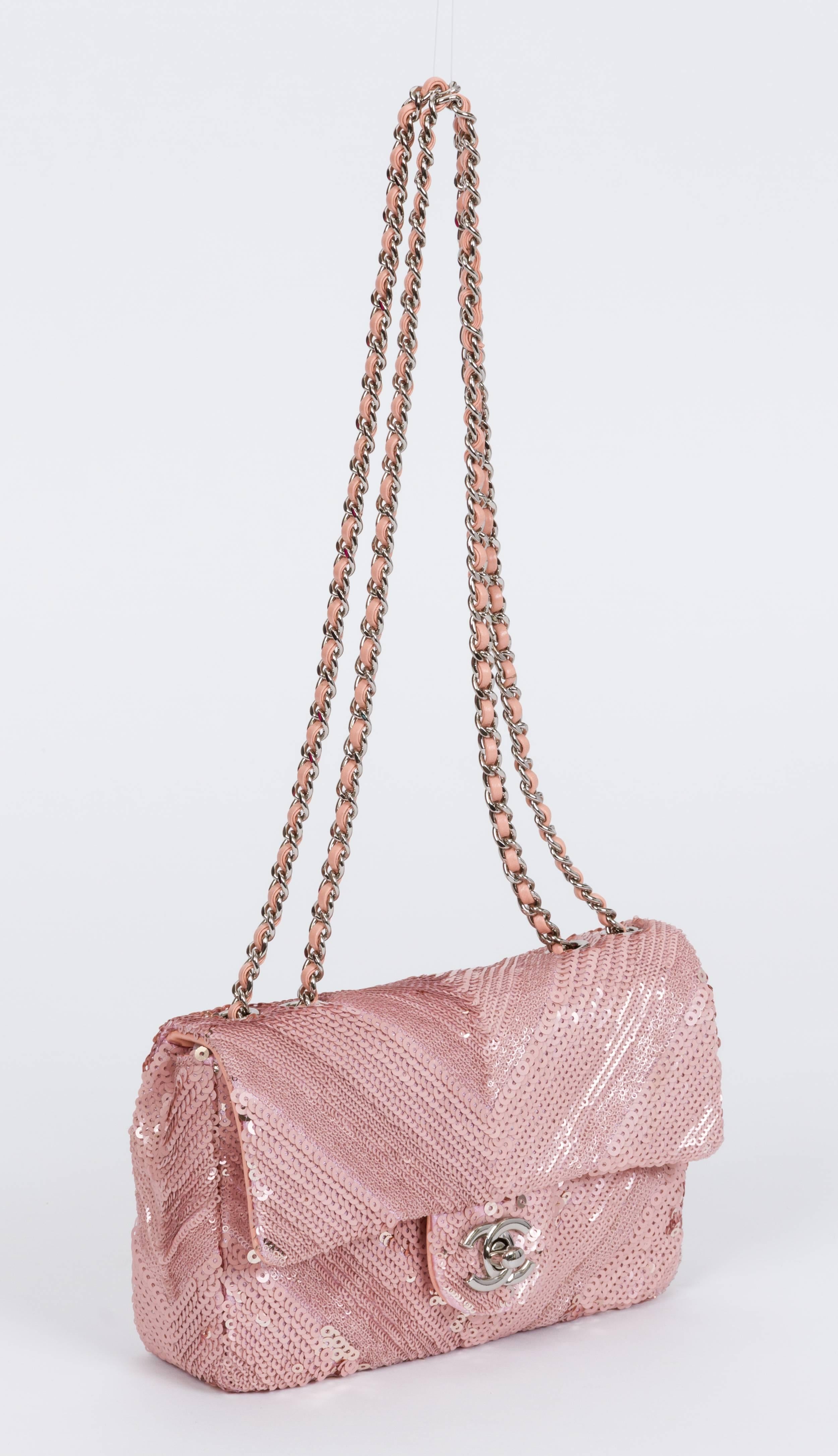 Chanel limited edition small single flap in pink sequins with silver metal chain. Soft pink lambskin interior. Can be worn also cross body. Shoulder drop 12