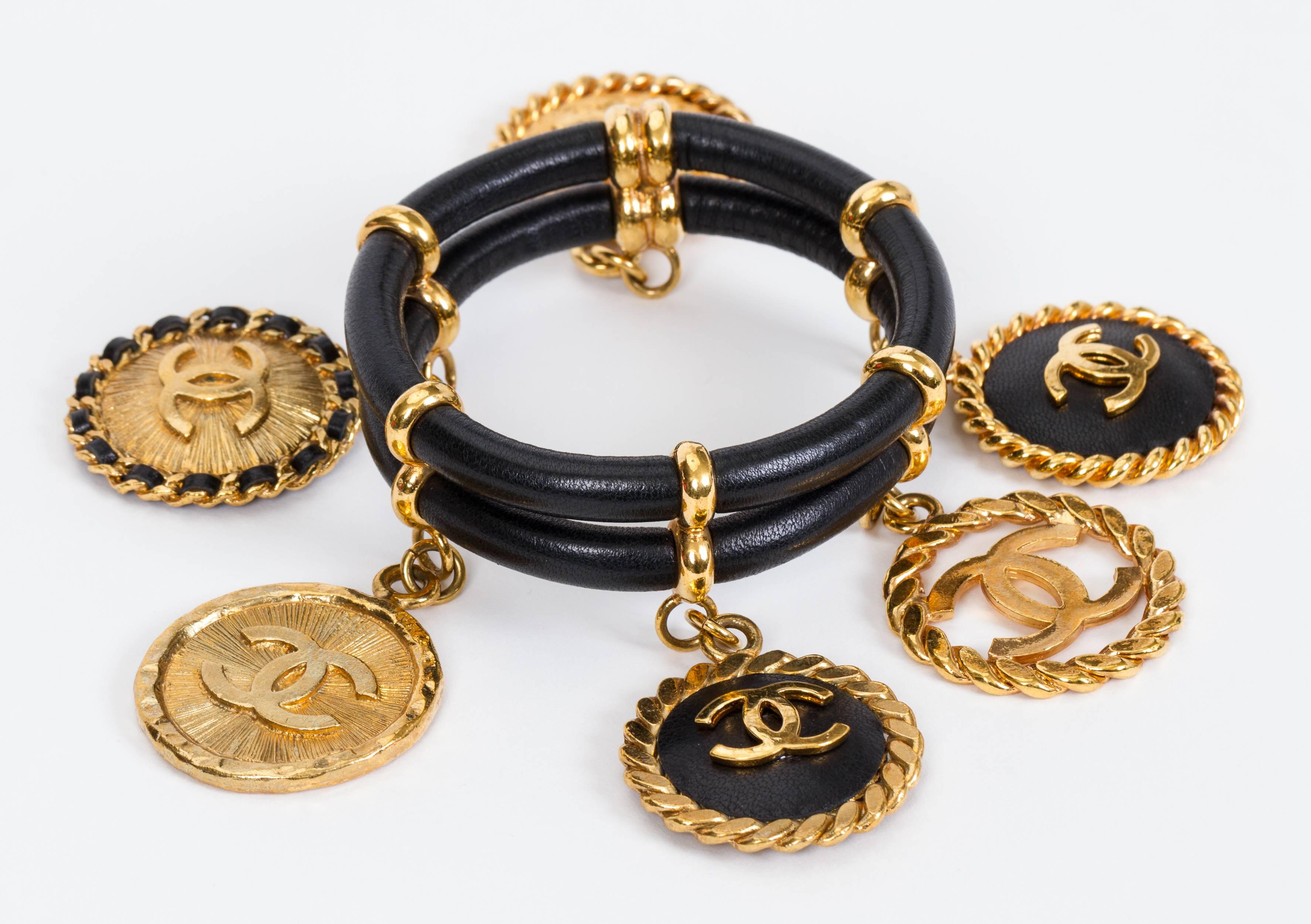 Chanel rare and collectible leather and gold metal charm bracelet from mid 80s. Designed by iconic Victoire de Castellaine. Charms measure 1.5