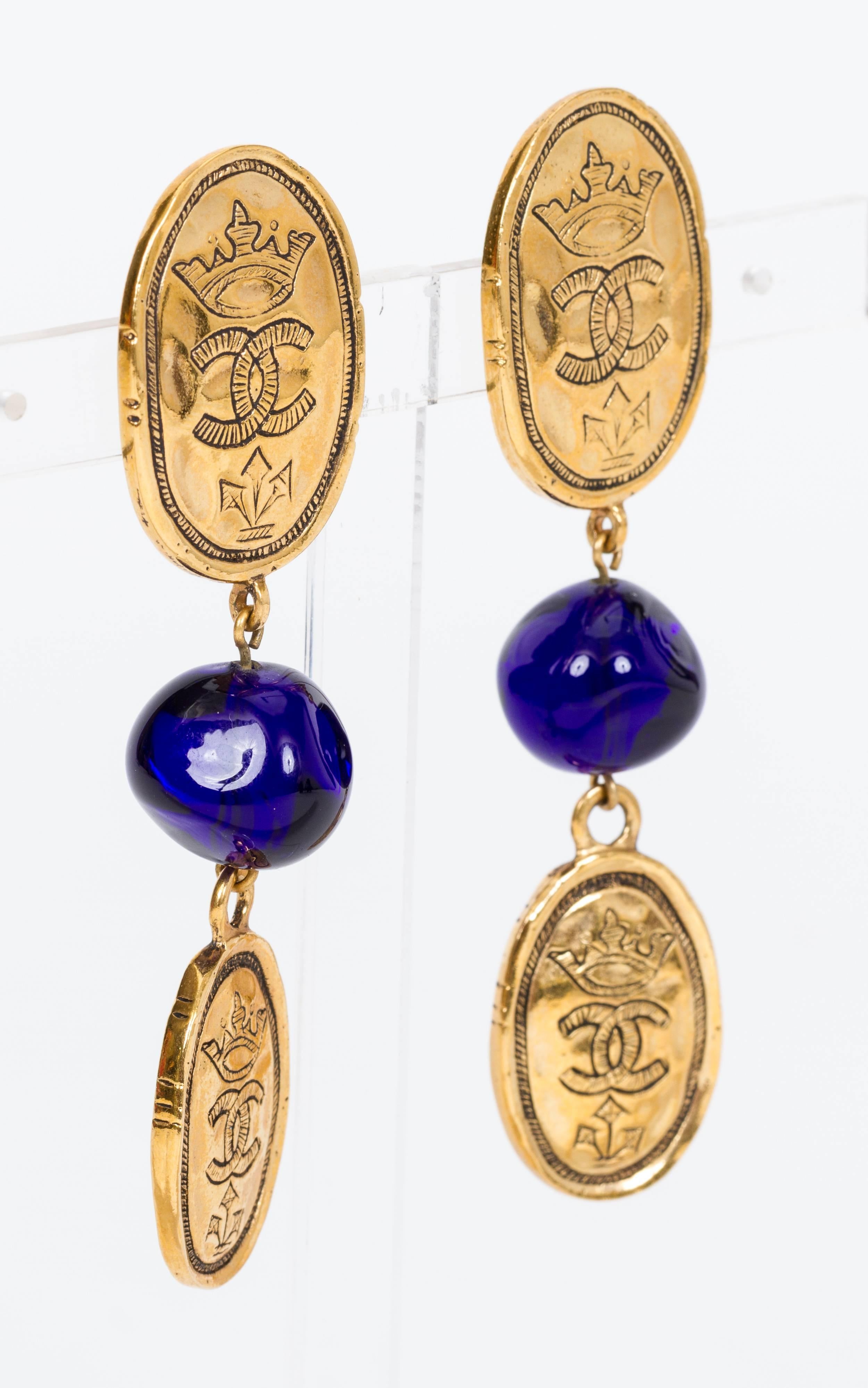 Chanel oval coin drop clip-back earrings with blue gripoix beads. Collection 28, circa 1985. Comes with original box.
