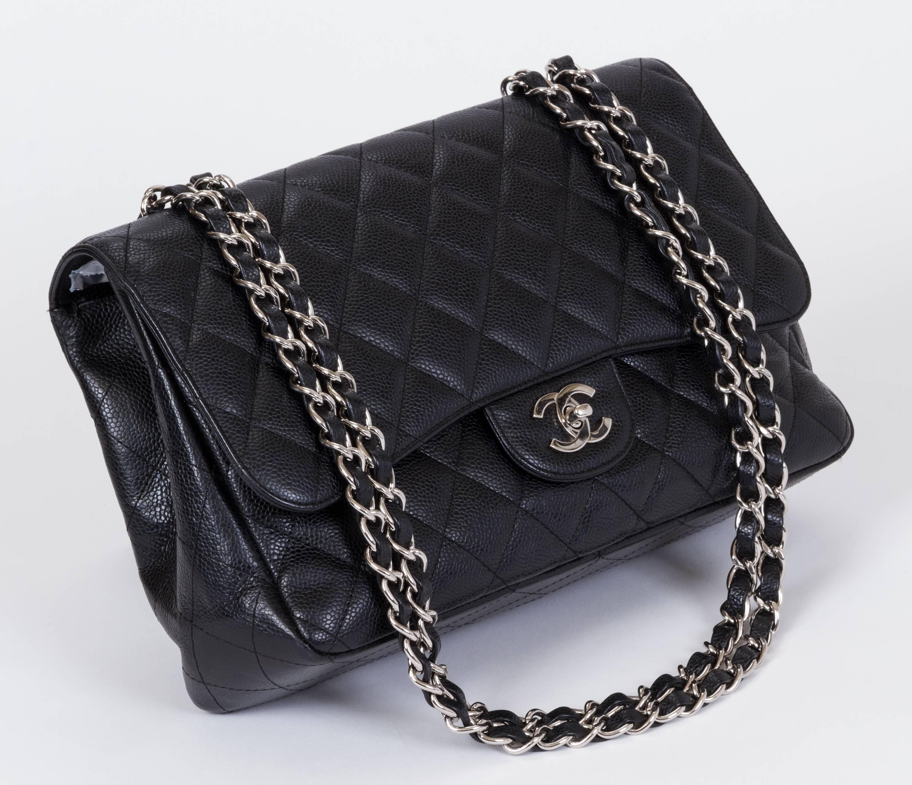 Chanel black caviar leather  quilted jumbo single flap. Excellent condition. Comes with hologram and original box . Measurements: 12