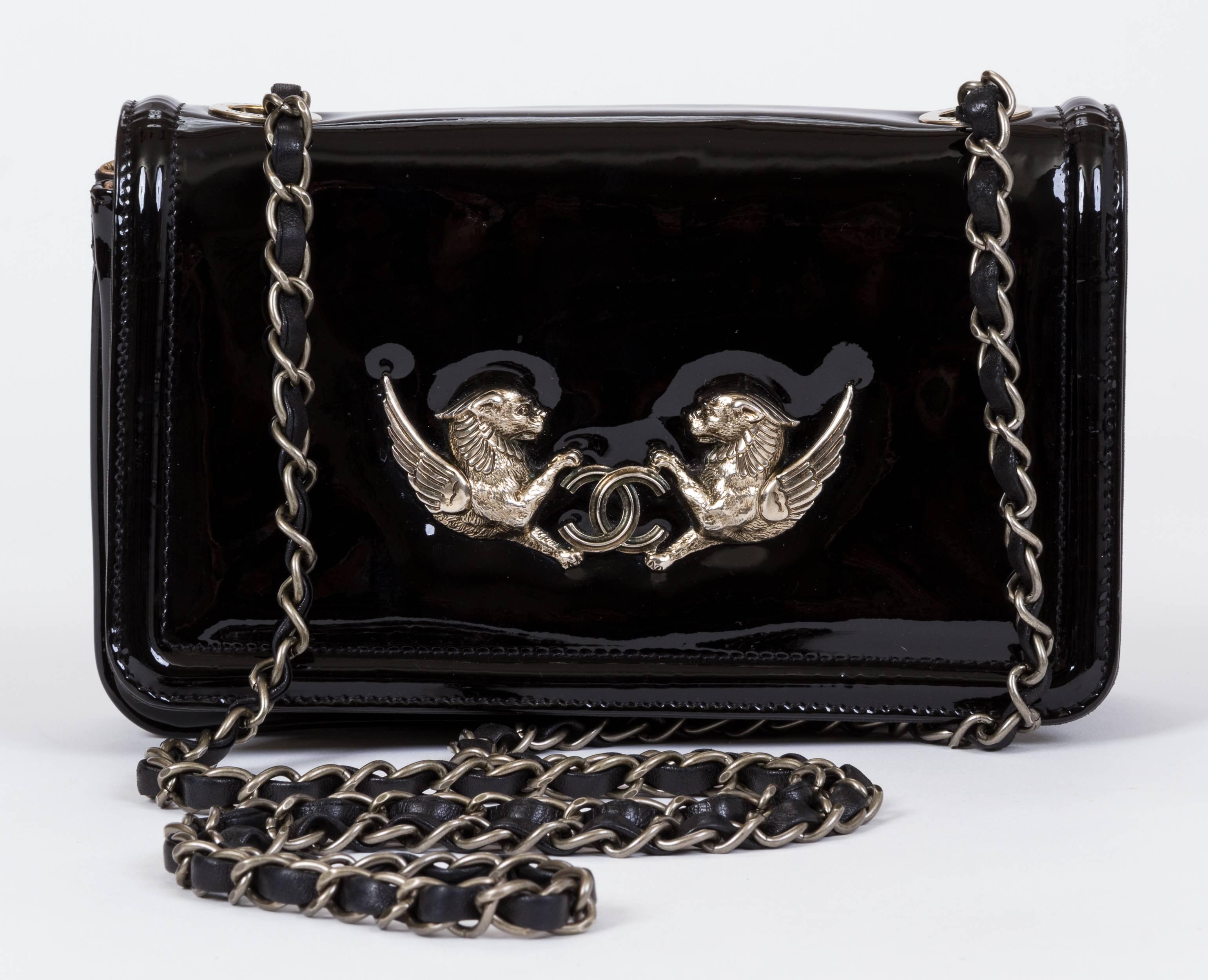 Chanel Paris Venise evening bag in black patent leather, black lambskin and gold leather interior. Winged bronze lions decoration. Can be worn cross body or shoulder . Shoulder drop 29