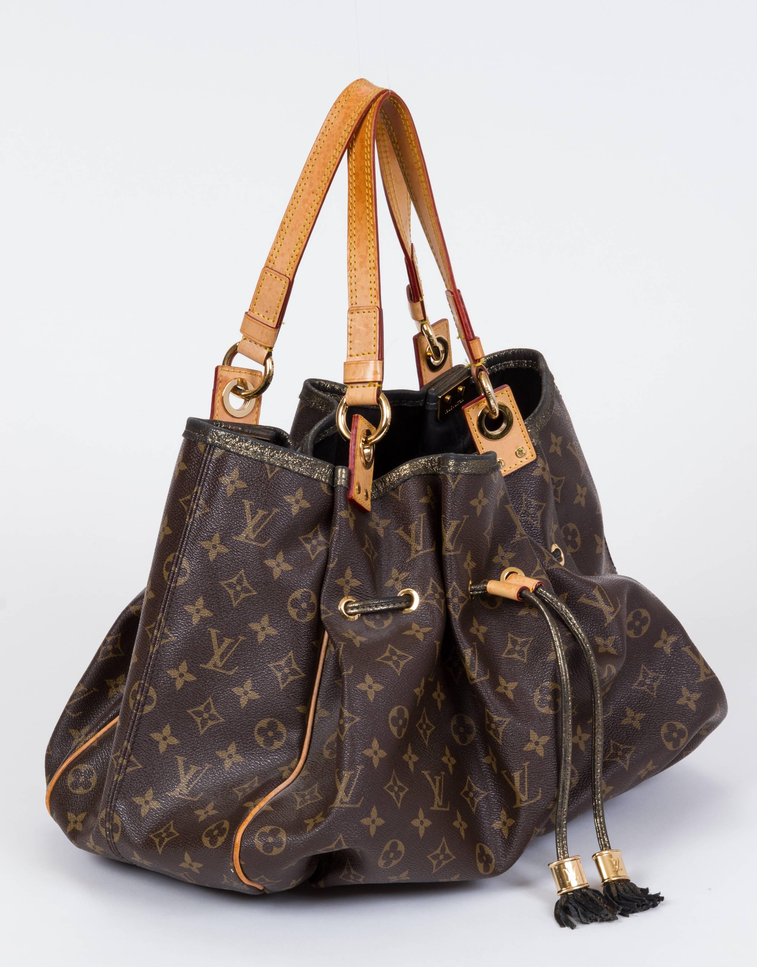 Louis Vuitton preowned shoulder tote in monogram canvas, natural cowhide straps and gold tone tassel and details. Minor wear on leather. Limited edition 2009, Madonna collection. Shoulder drop 5