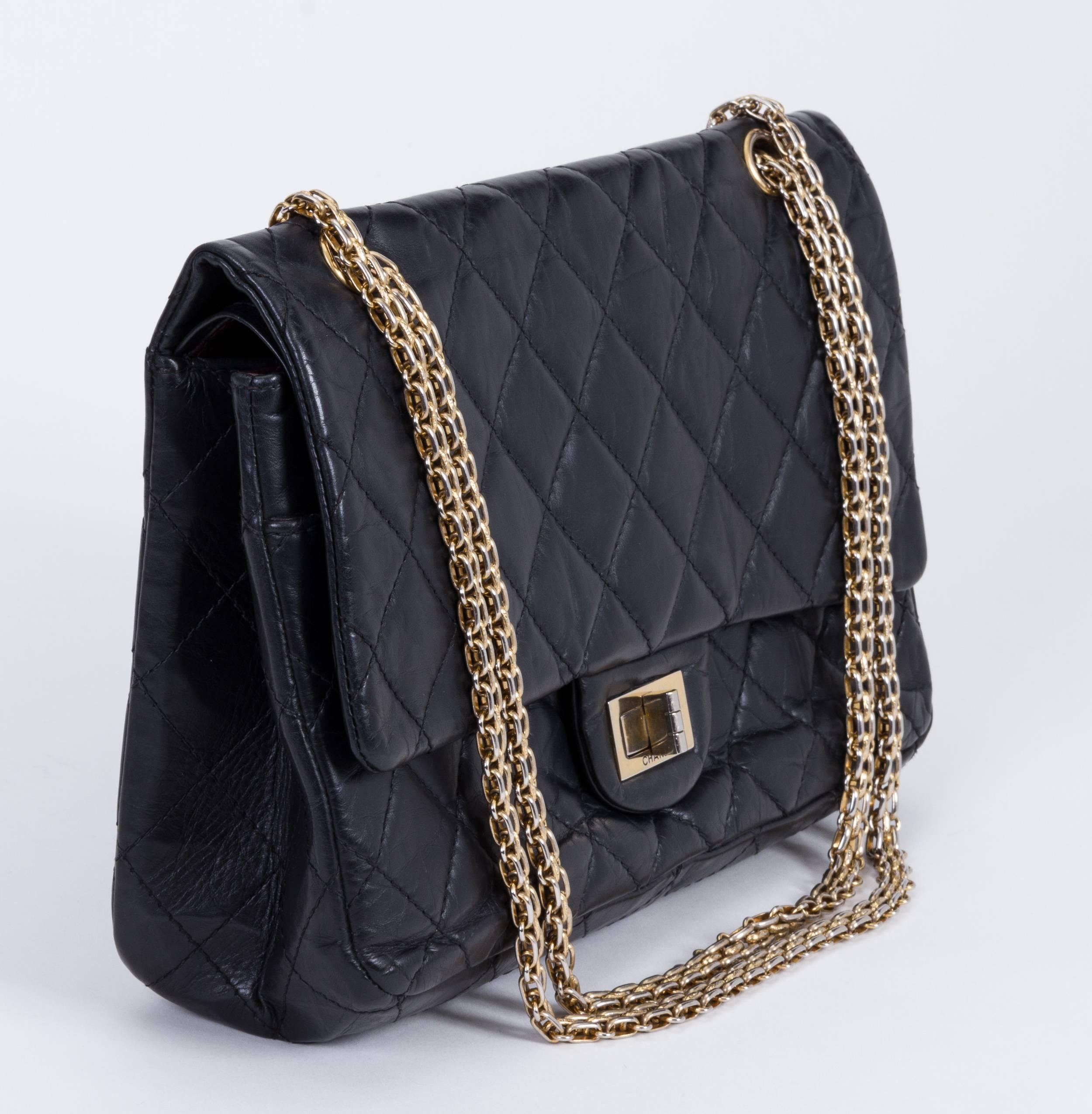 Chanel jumbo reissue double-flap bag. Black distressed leather and gold tone hardware metal. Can be worn cross body. Shoulder drop: 11