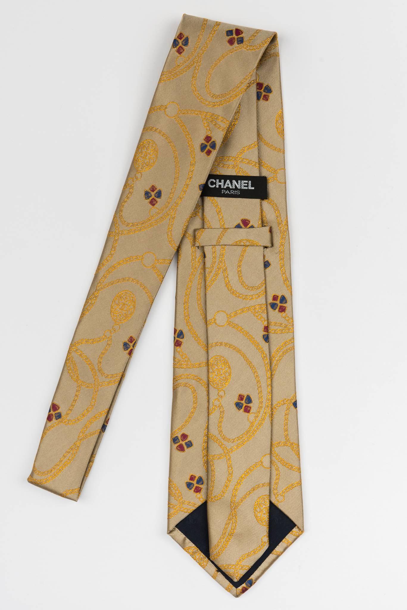 Chanel new in the original packing. Gold silk tie with multi colored gripoix detail. Excellent unworn condition.