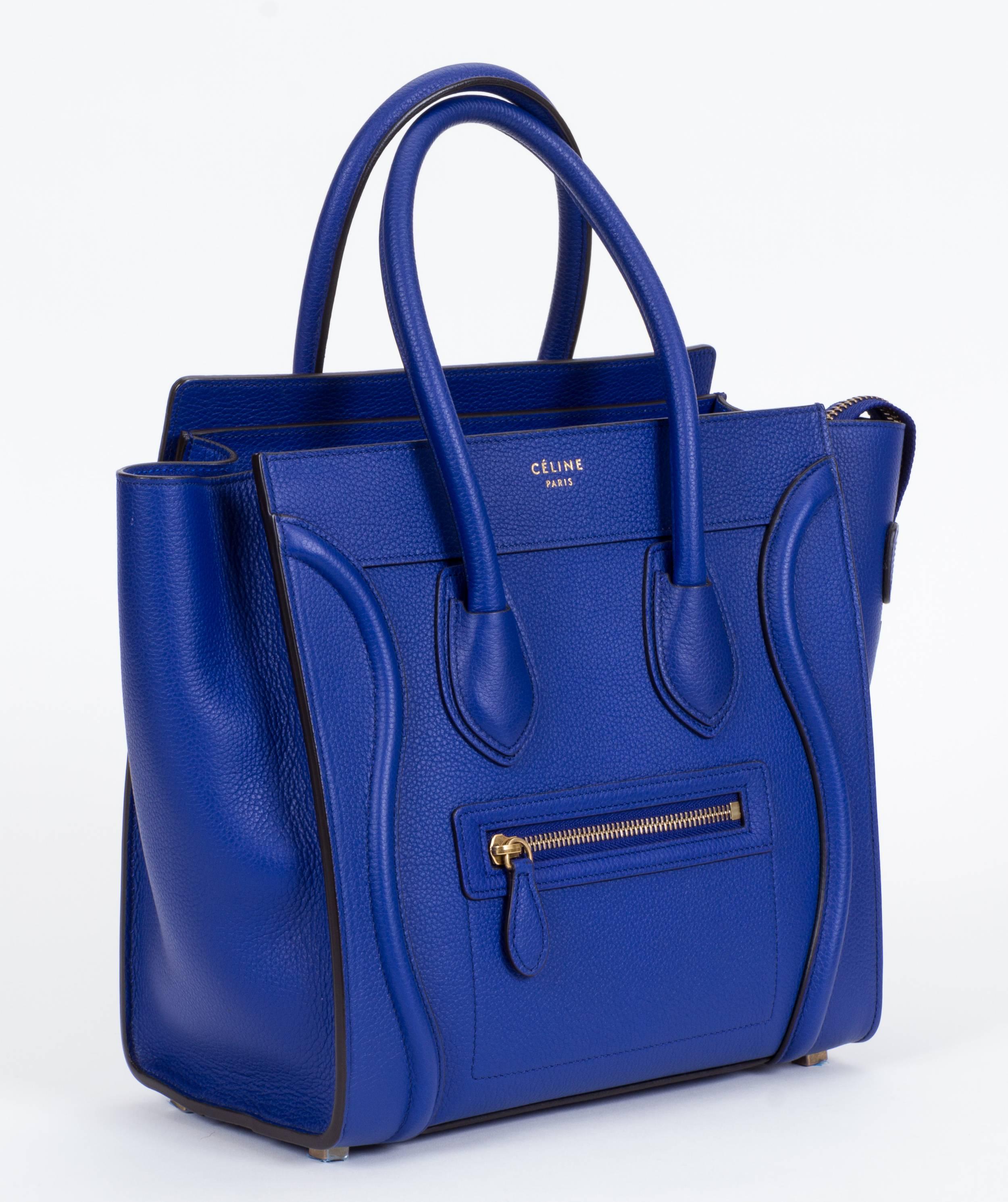 Celine brand new micro luggage handbag in indigo blue calfskin with interior suede lining. Zipper closer and outer zipped pocket, inner zipped pocket and double flat pockets. Comes with original tag and dust cover.