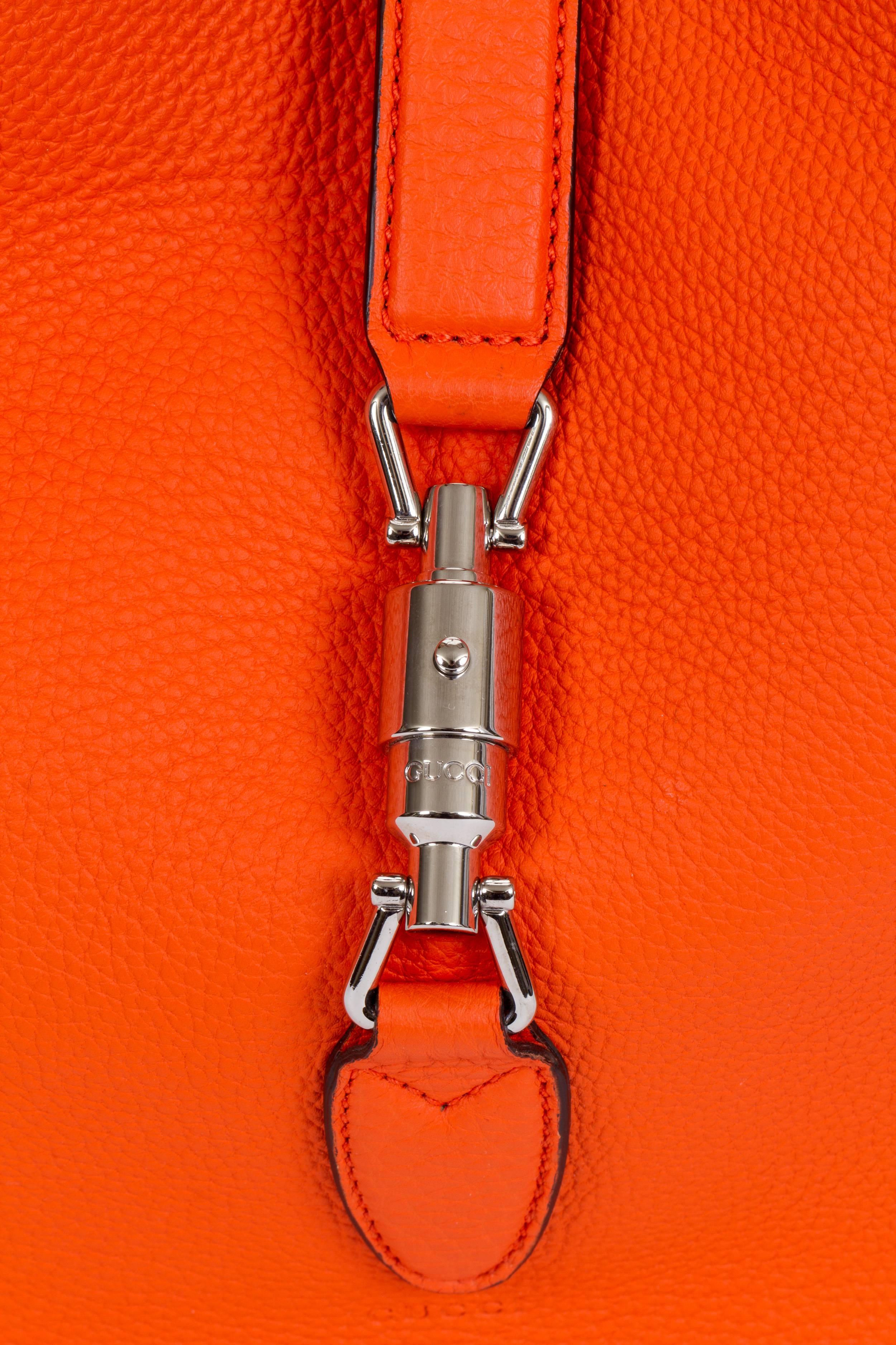 Gucci brand new Jackie hobo bag in bright orange taurillon leather and silver tone hardware. Interior attached zipped pocket. Handle drop 9.4
