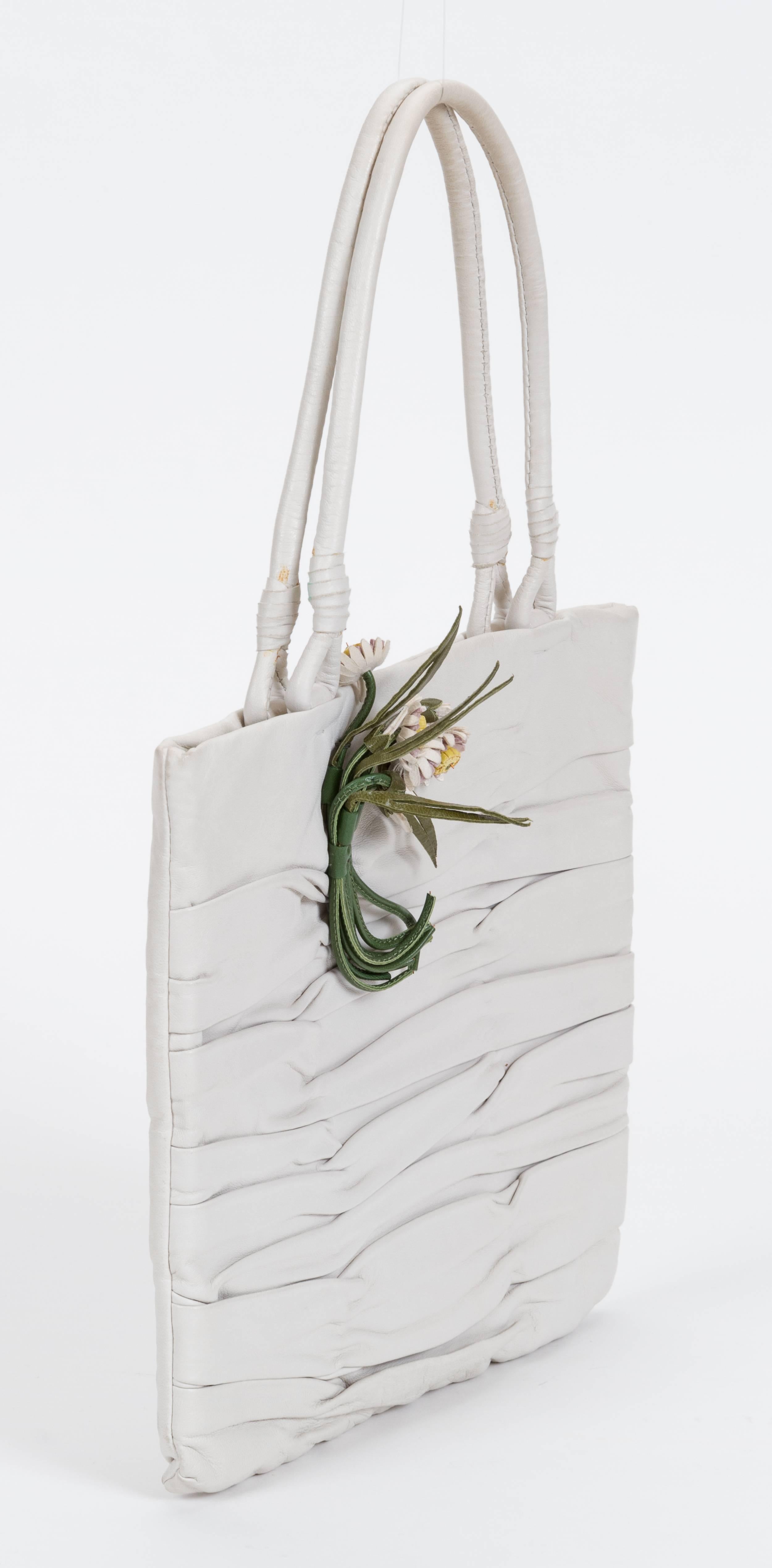 Prada 90s vintage white lambskin handbag with flower detail. Green silk interior. One minor stain on back of the bag. Handle drop 5.5