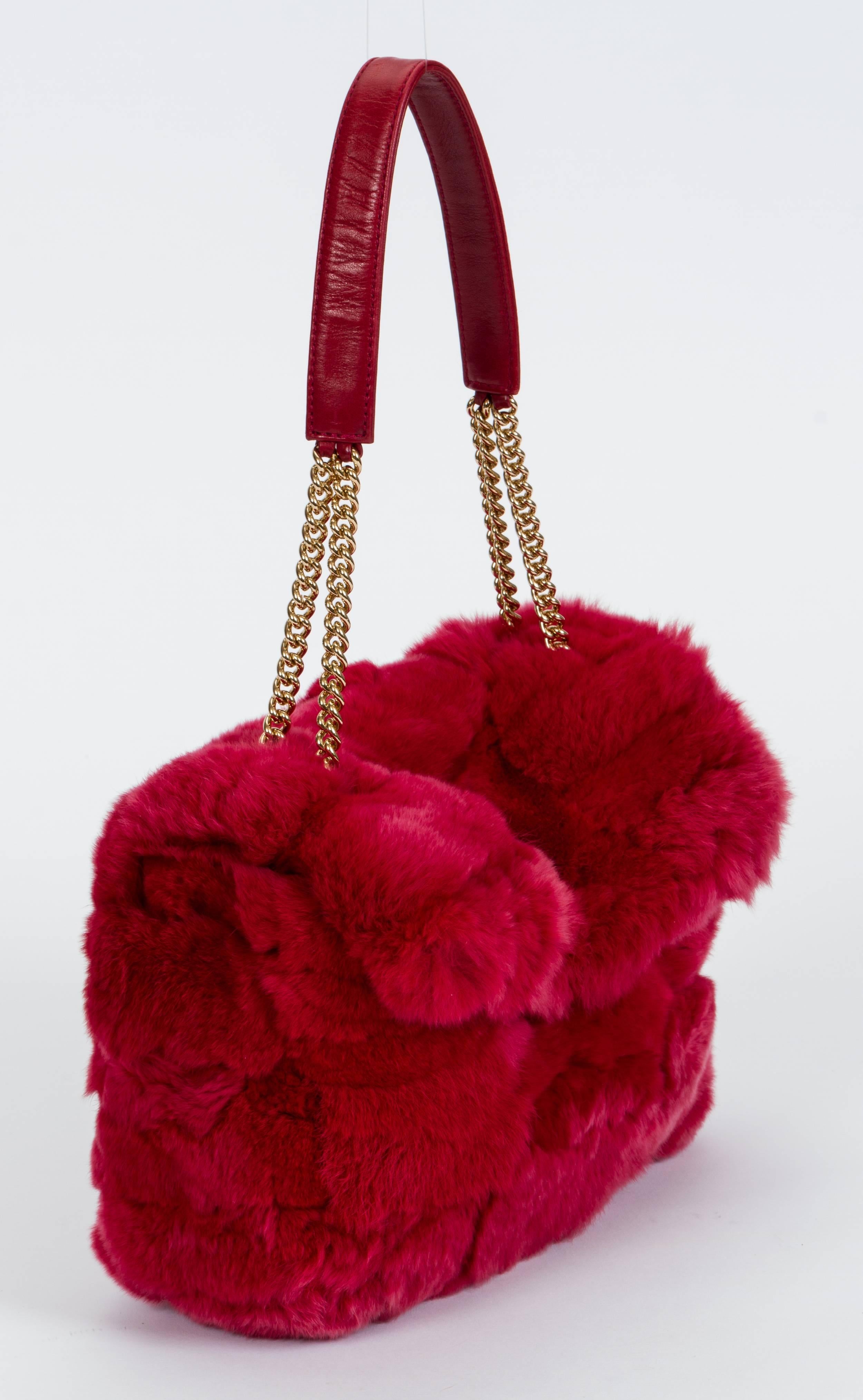 Red chinchilla flap bag by Chanel from 2005. It features a red leather interior and gold hardware. Minor wear . Handle drop 8