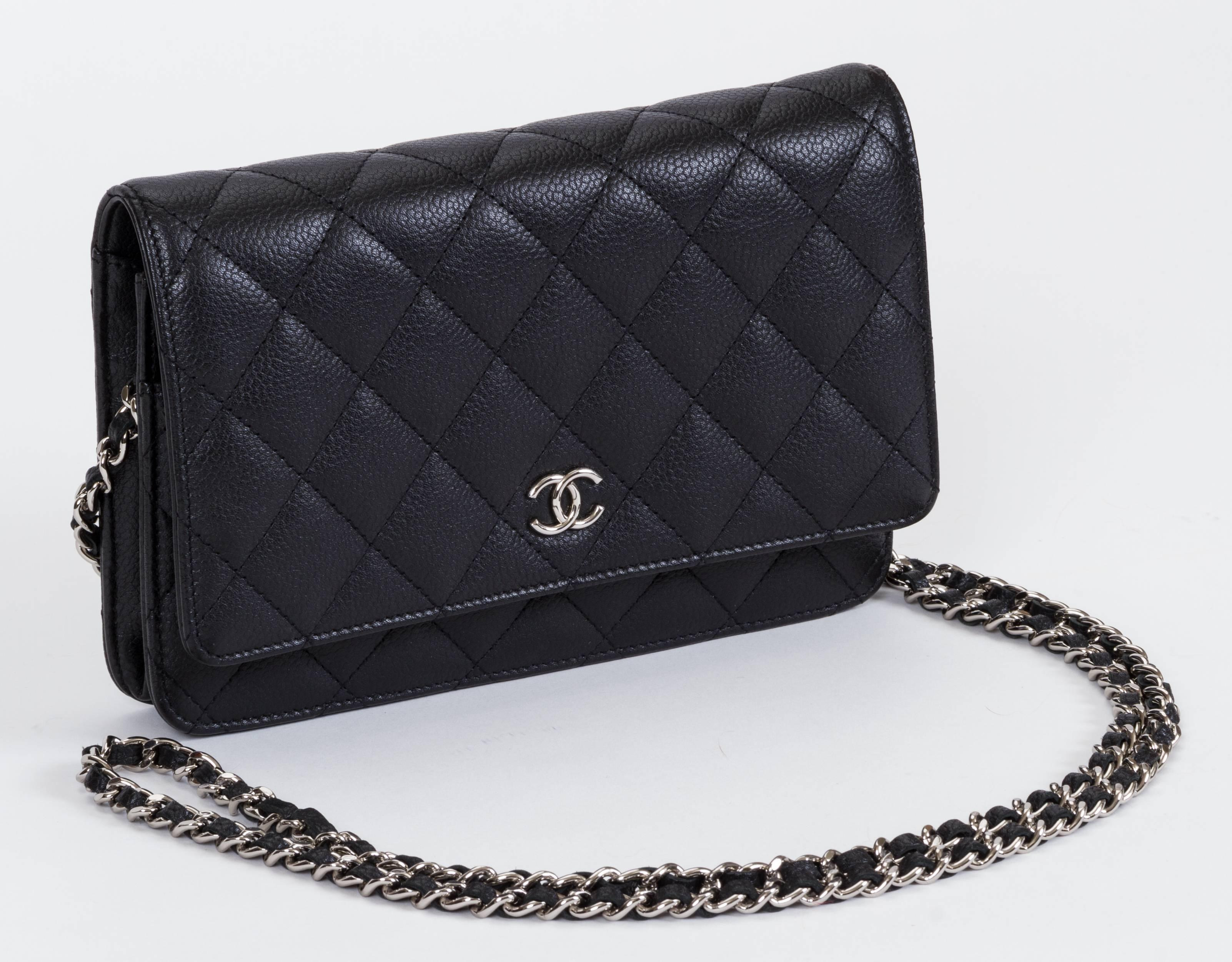 Chanel black caviar quilted wallet on a chain with silver tone hardware. Can be worn as a clutch or as a cross body. New in box. Measurements 7.5