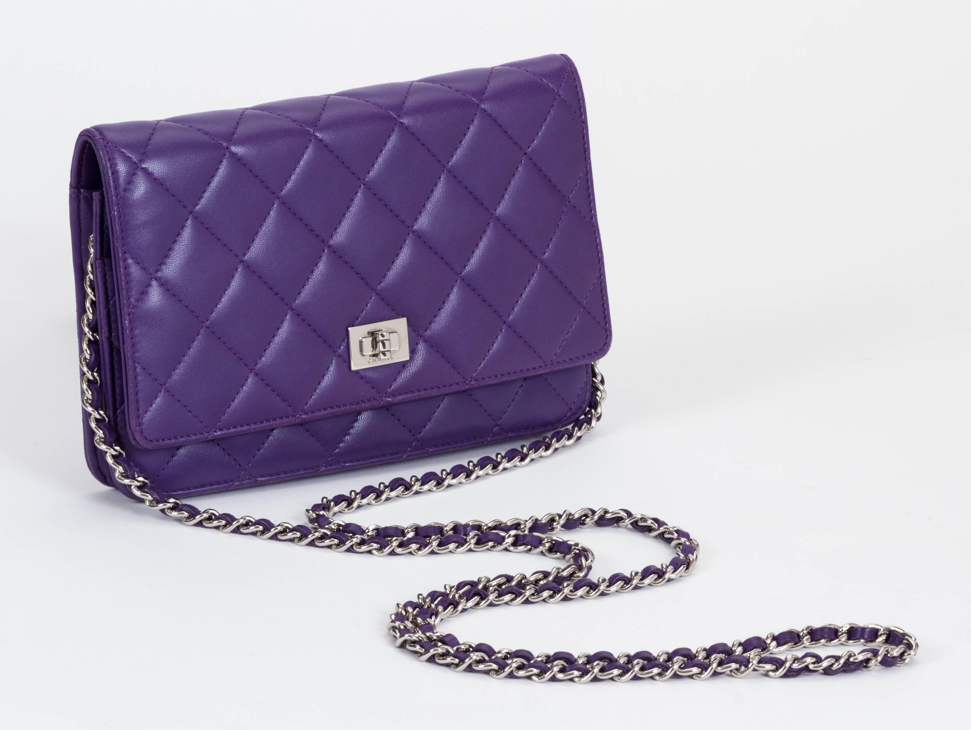 Chanel purple lambskin reissue quilted wallet on a chain with silver tone hardware. Can be worn as a clutch or as a cross body. Very good condition. Measurements 7.5