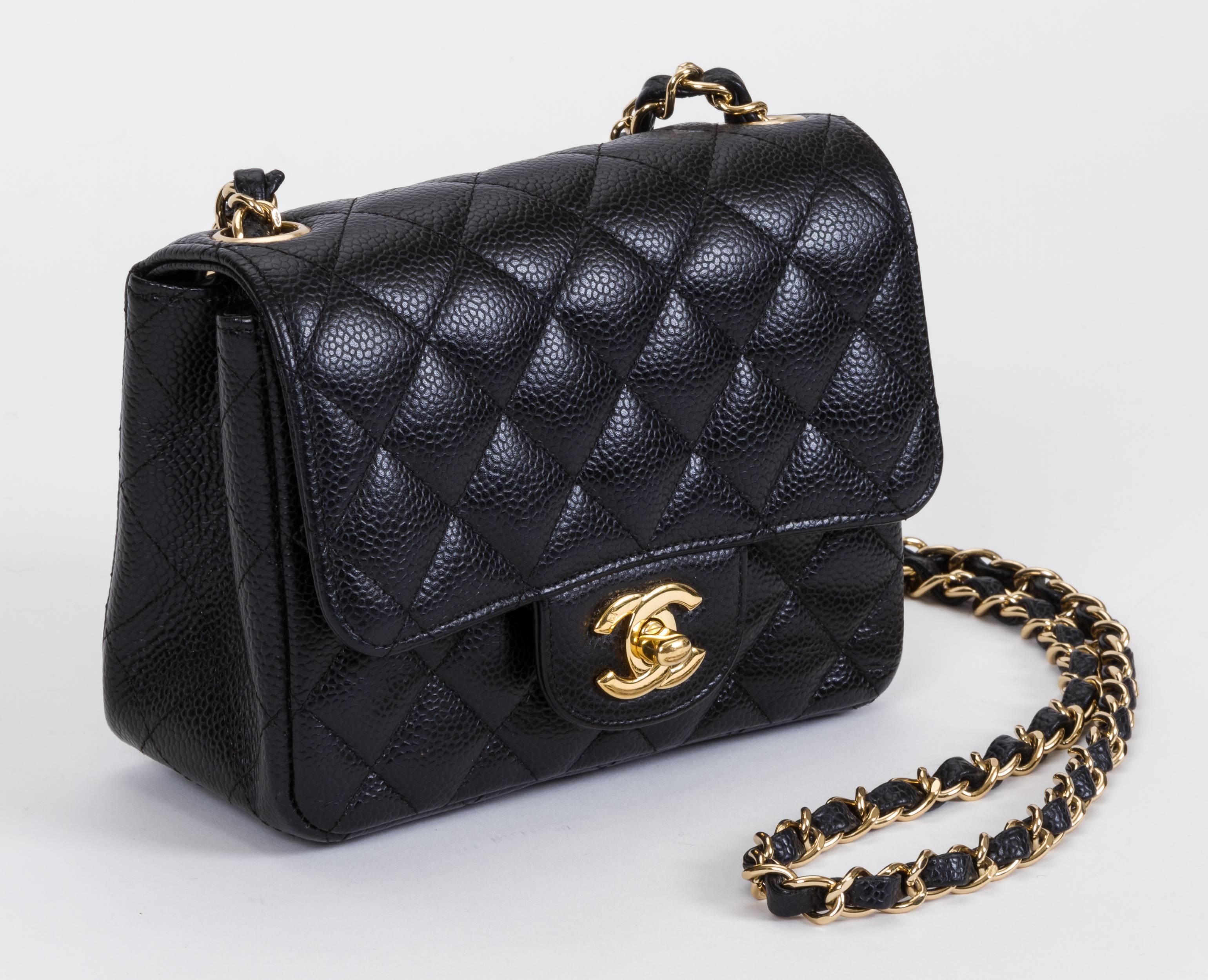 Chanel black caviar quilted cross body mini flap bag. One exterior back pocket and one interior zipped compartment. Gold tone hardware. Shoulder drop 21