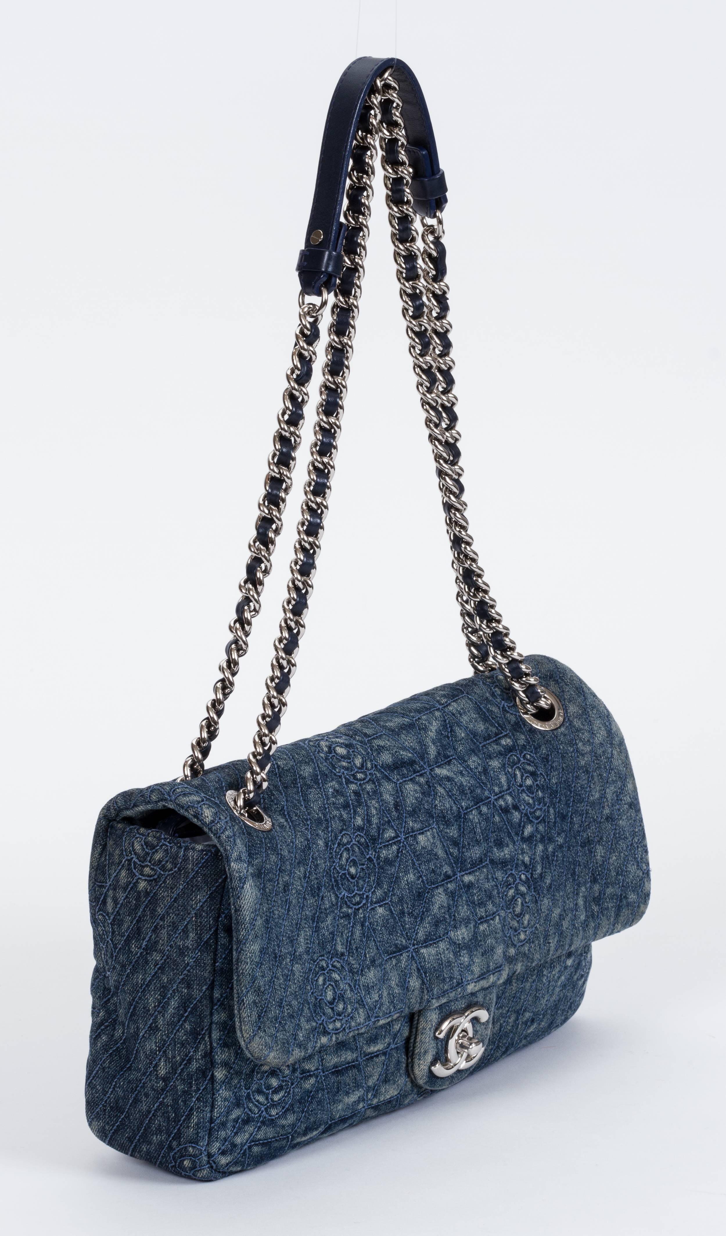 Chanel maxi denim camellia embossed flap bag with silver tone hardware. Shoulder drop 11.5