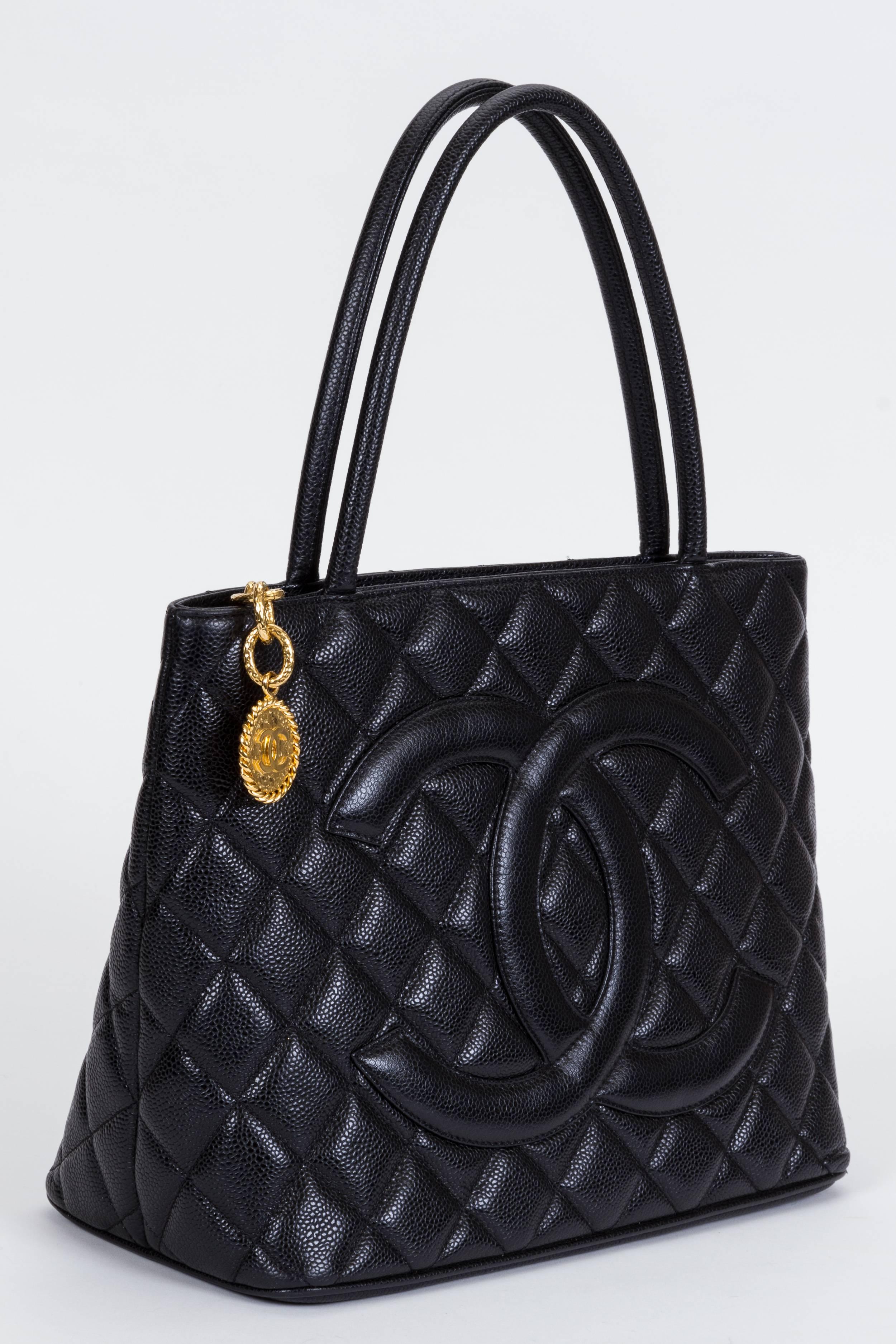 Chanel black caviar quilted medallion tote with gold tone hardware. Handle drop, 6.5