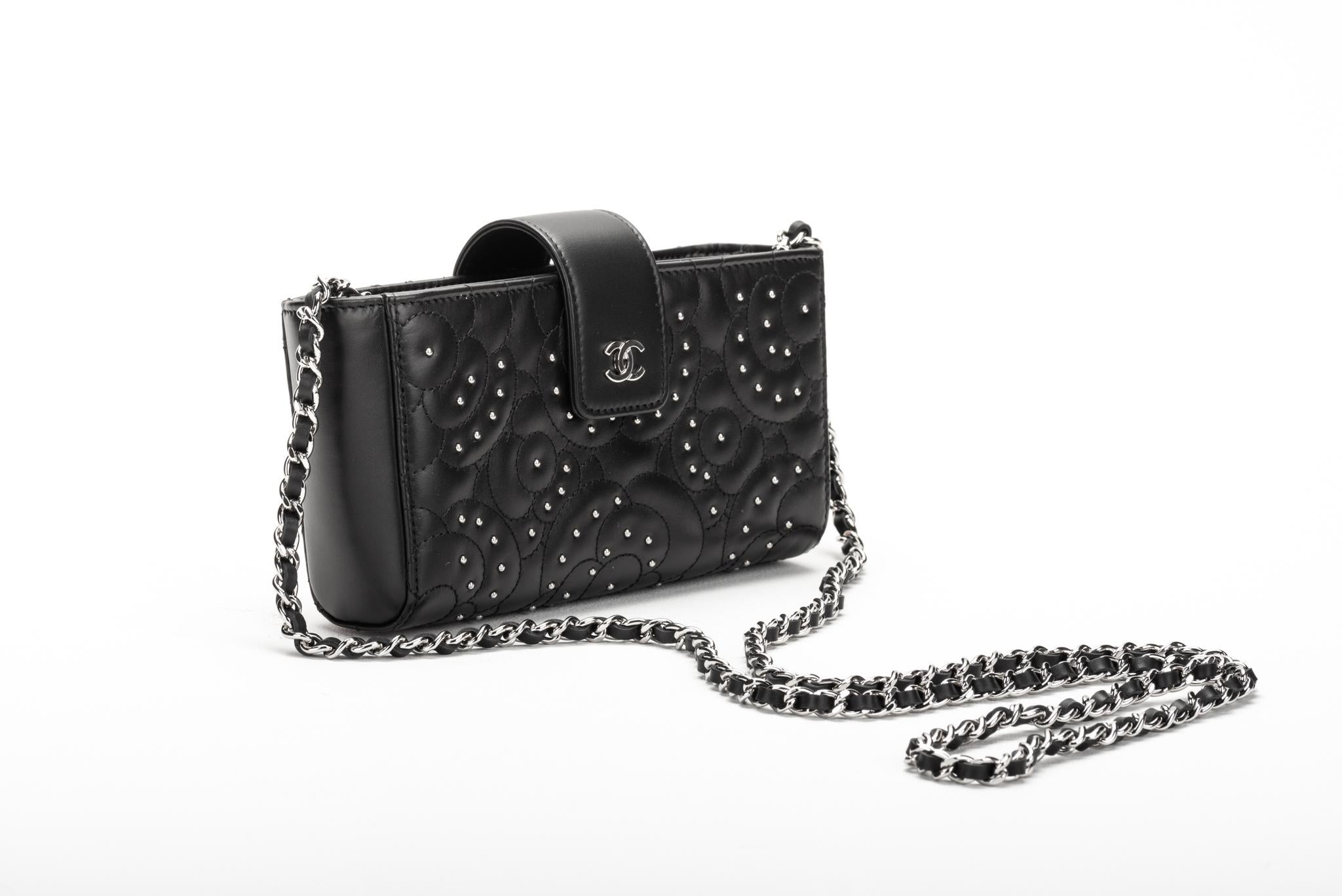 New in box, Chanel black lambskin camellia studs cross body bag. One zipped center compartment and two side open pockets. Detachable strap, shoulder drop 24