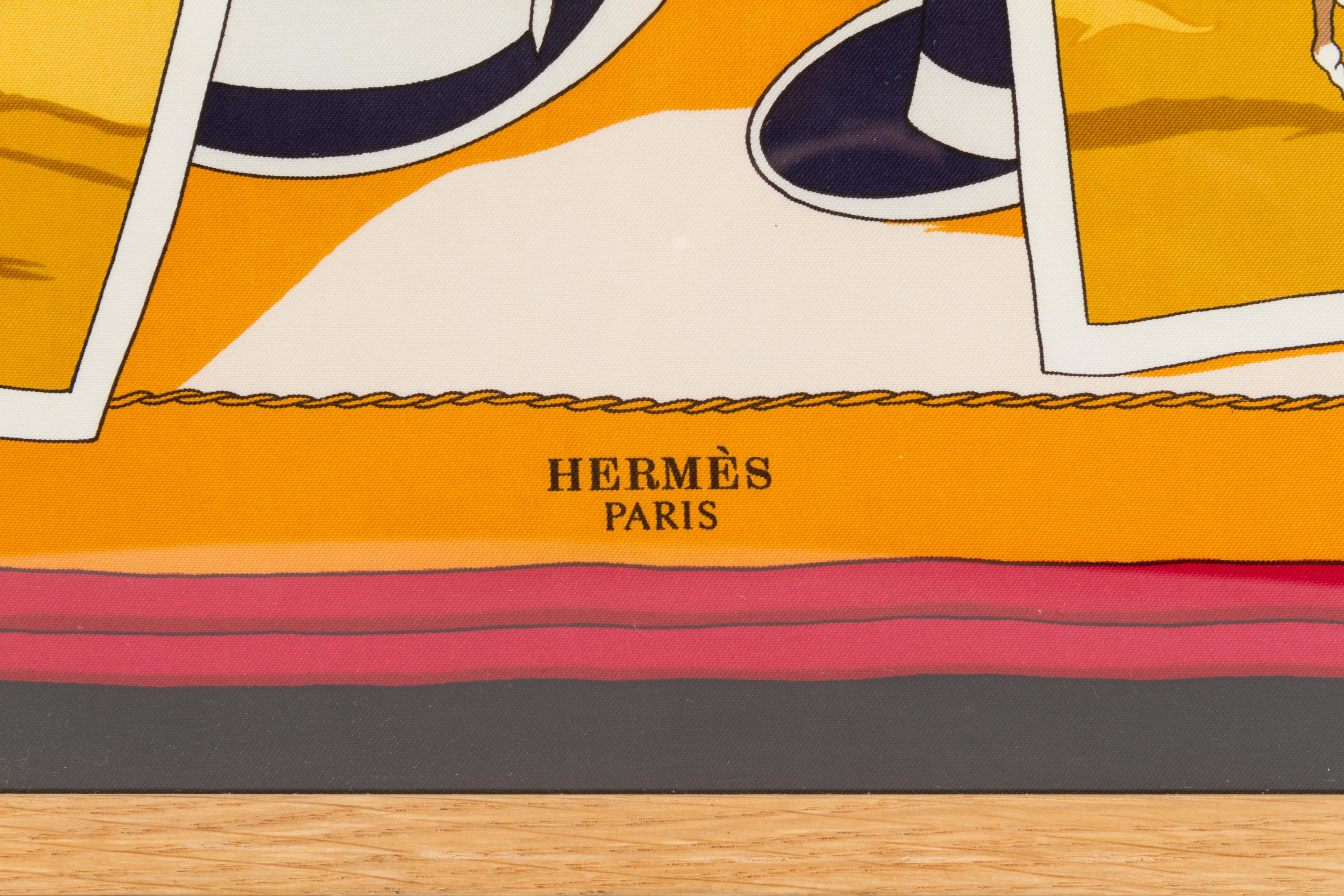 Hermès silk scarf displayed in a natural wood frame under Plexiglas. Scarf, 35