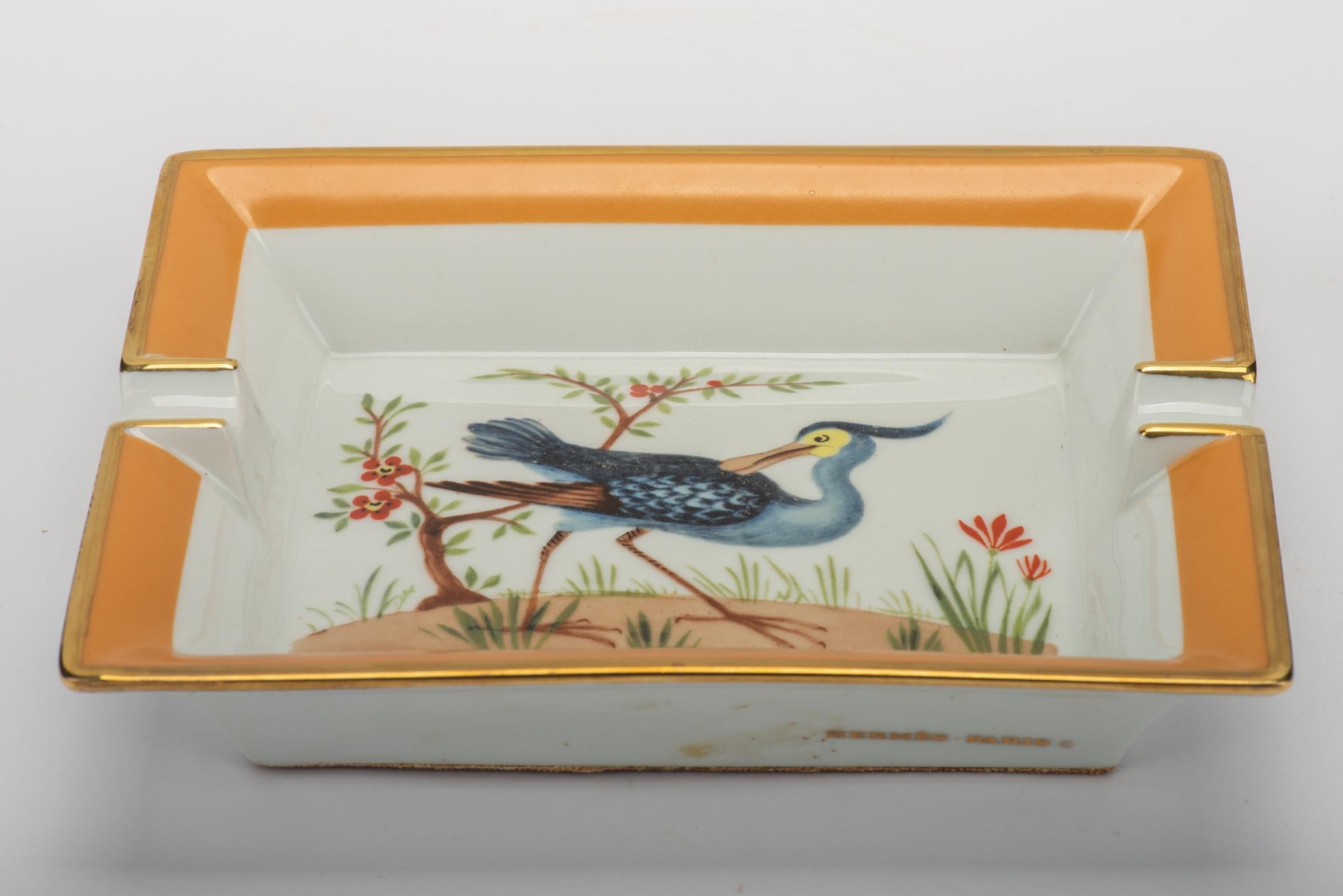 Hermès Limoges porcelain ashtray with blue bird print. Excellent condition. Comes with original box.