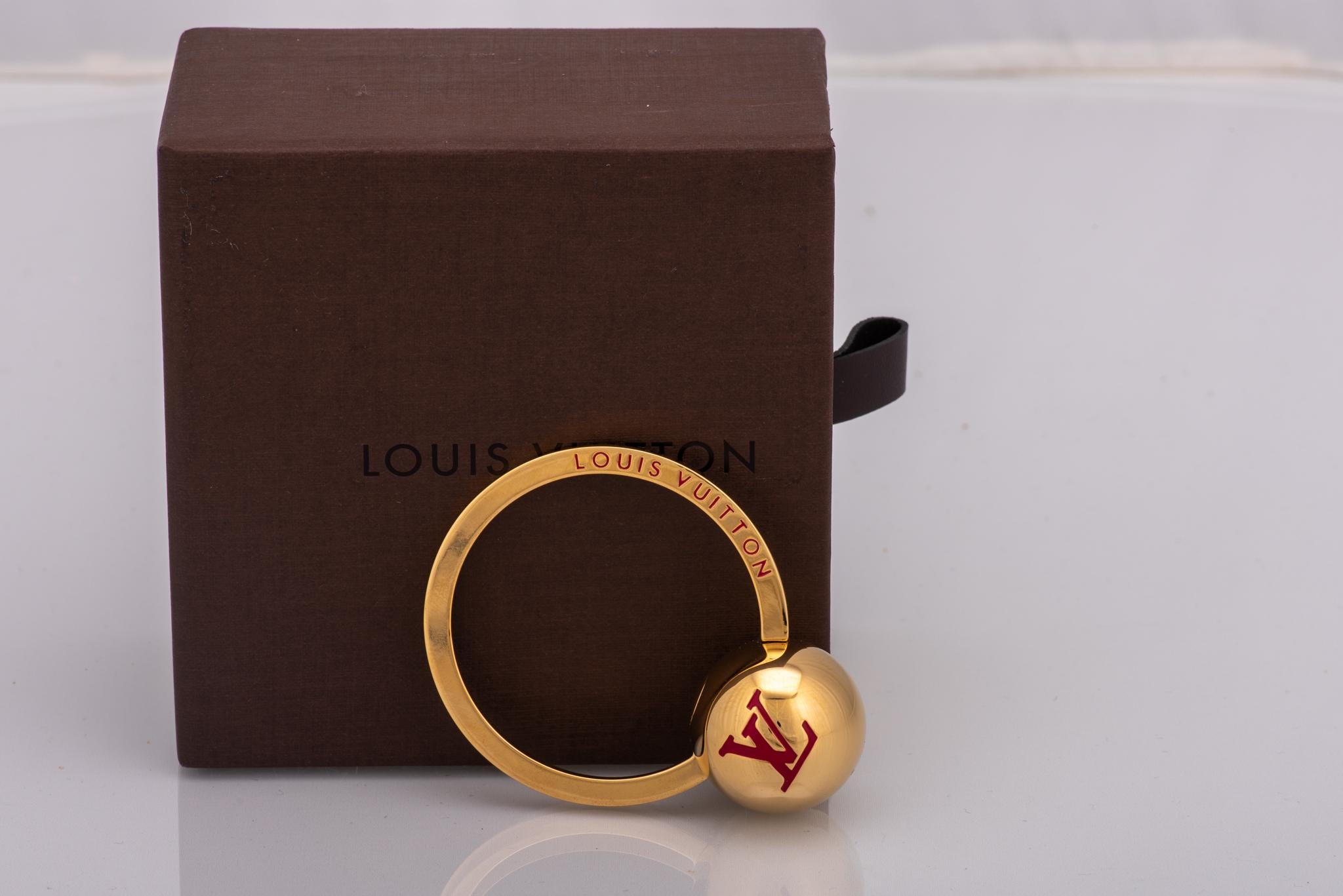 Louis Vuitton gold and enamel ring keychain. Brand new with original box and duster.