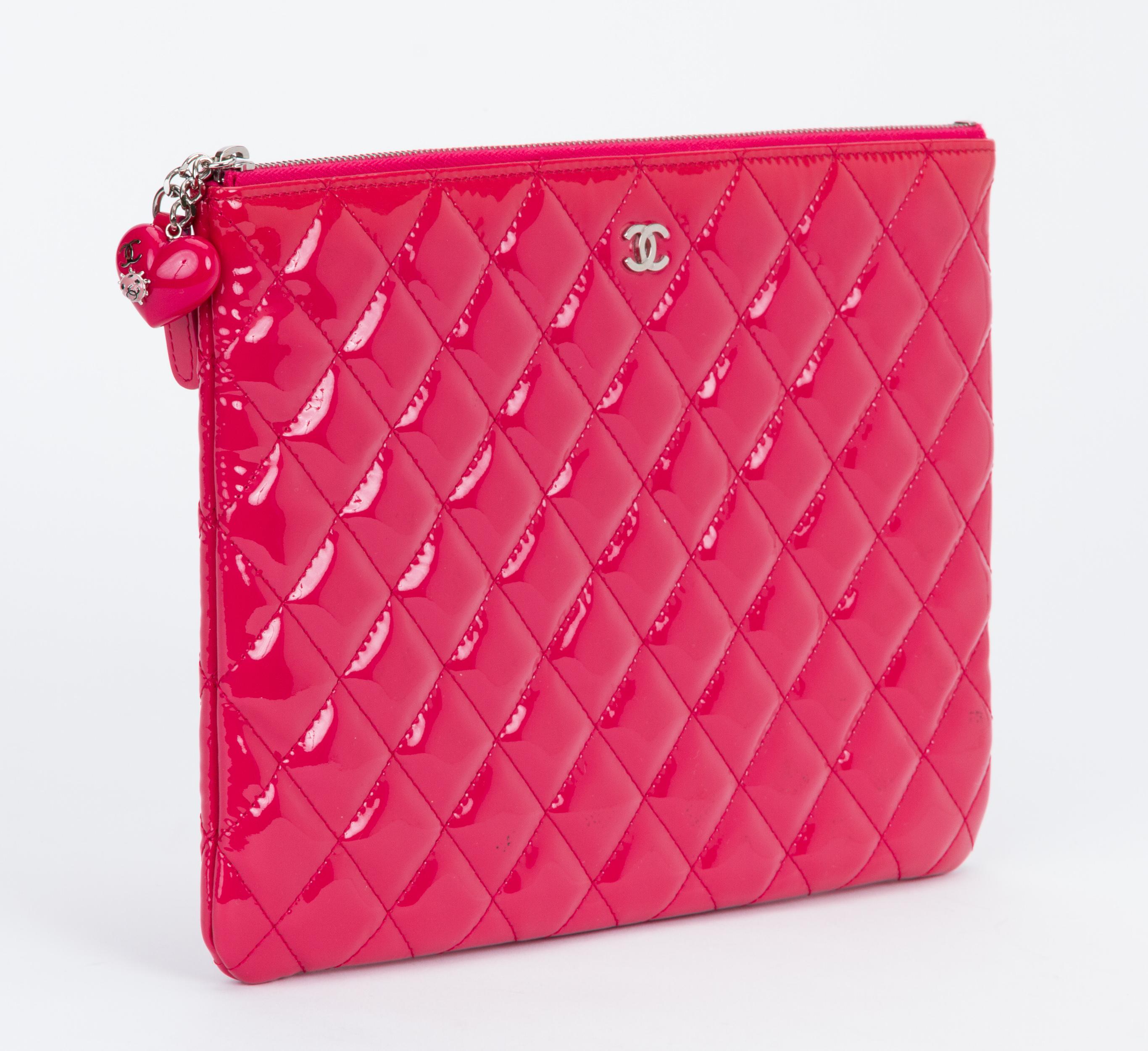 Chanel hot pink quilted patent leather clutch with heart charm. Excellent condition. Collection spring 2015. Comes with hologram, id card, dust bag and original box.