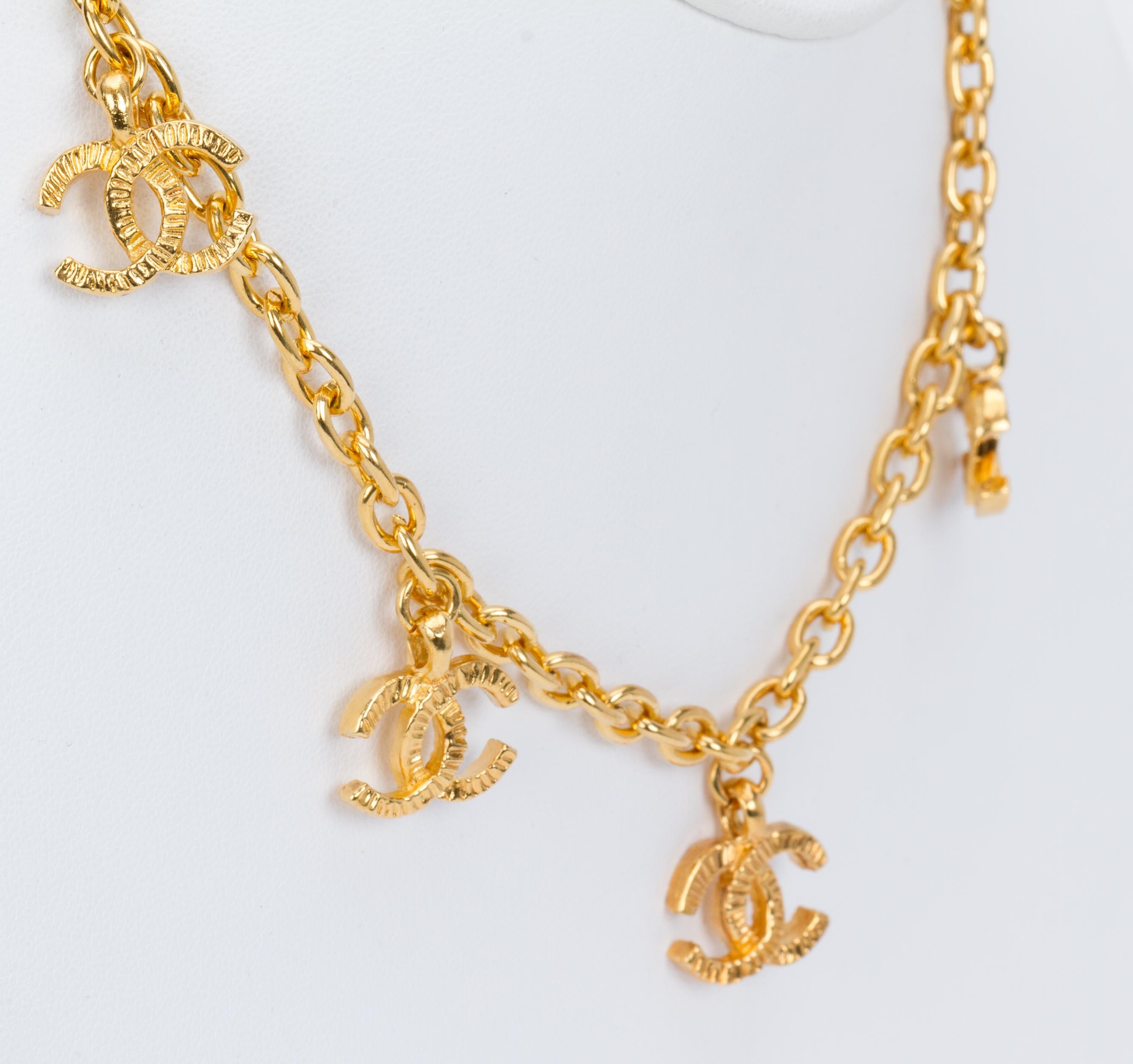 Chanel 70s cc dangling logo choker necklace. Gold tone hardware. Comes with original box.