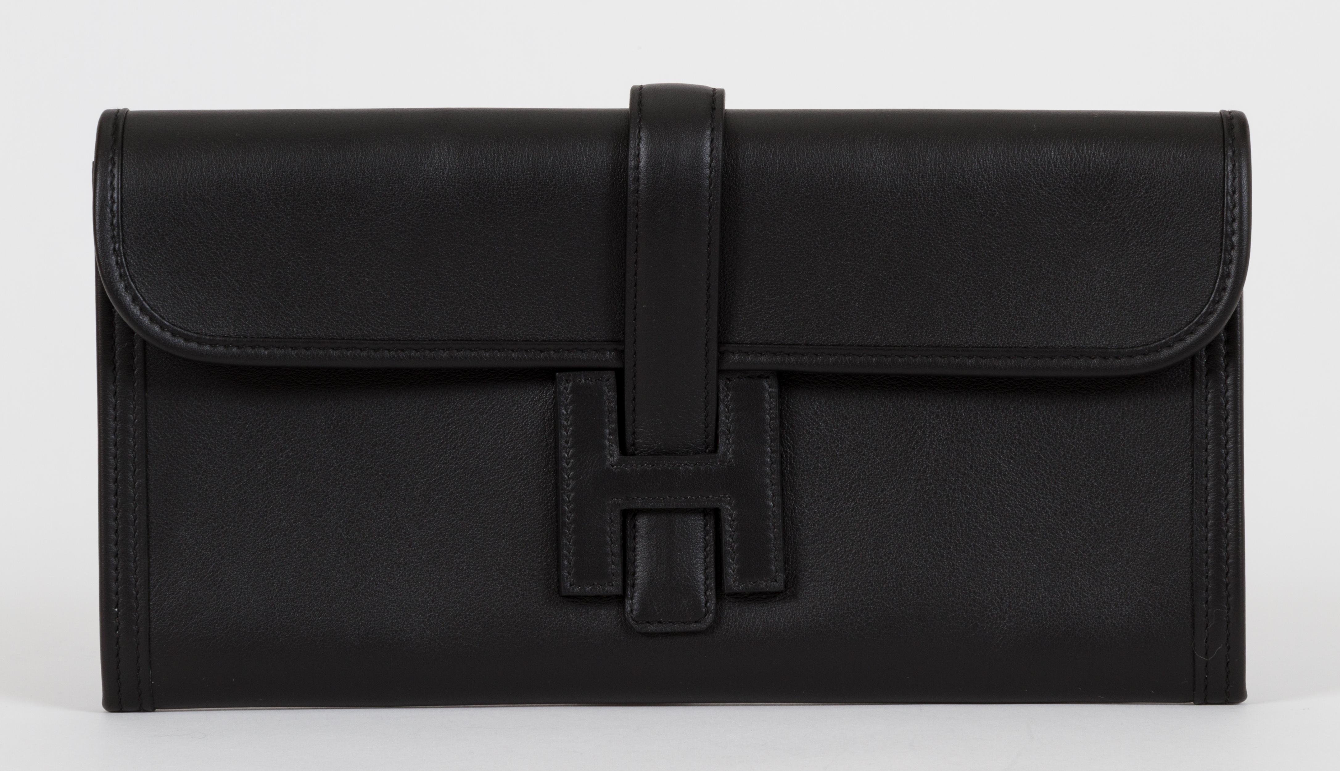 Hermès Jige clutch in black swift leather brand new in box. Letter C for 2018. Comes with original dust bag, felt, box, ribbon and blacked out copy of receipt.