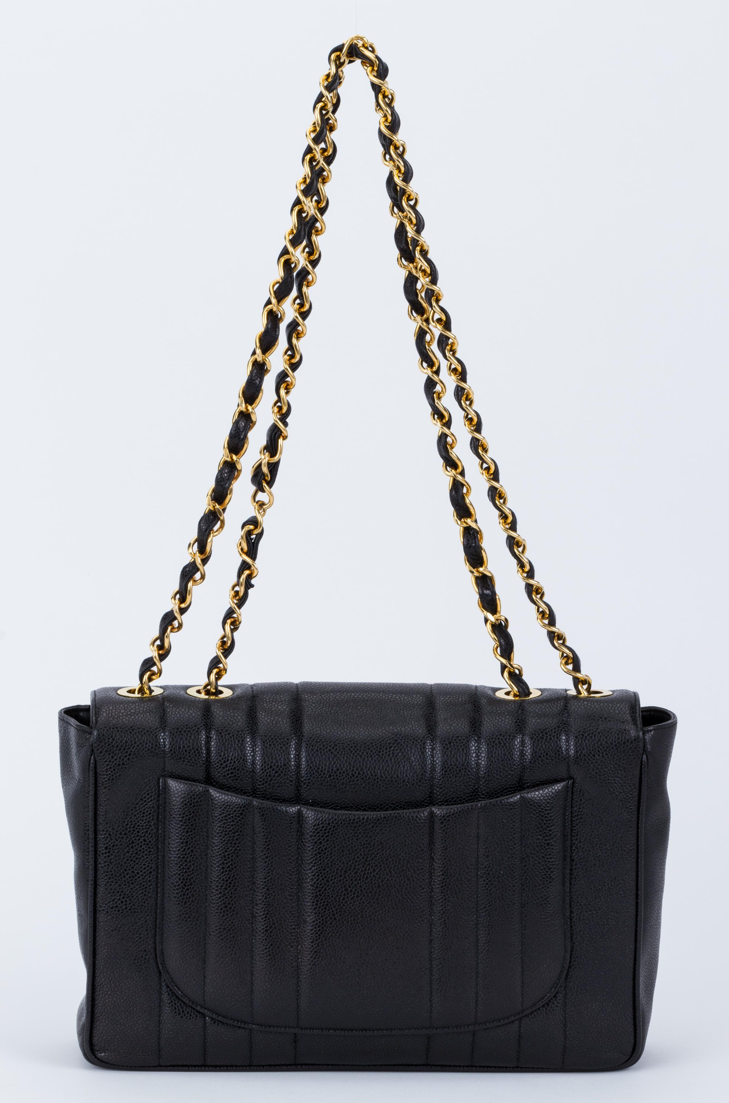 Chanel black caviar vertical quilted jumbo flap with gold tone hardware. Shoulder drop 14