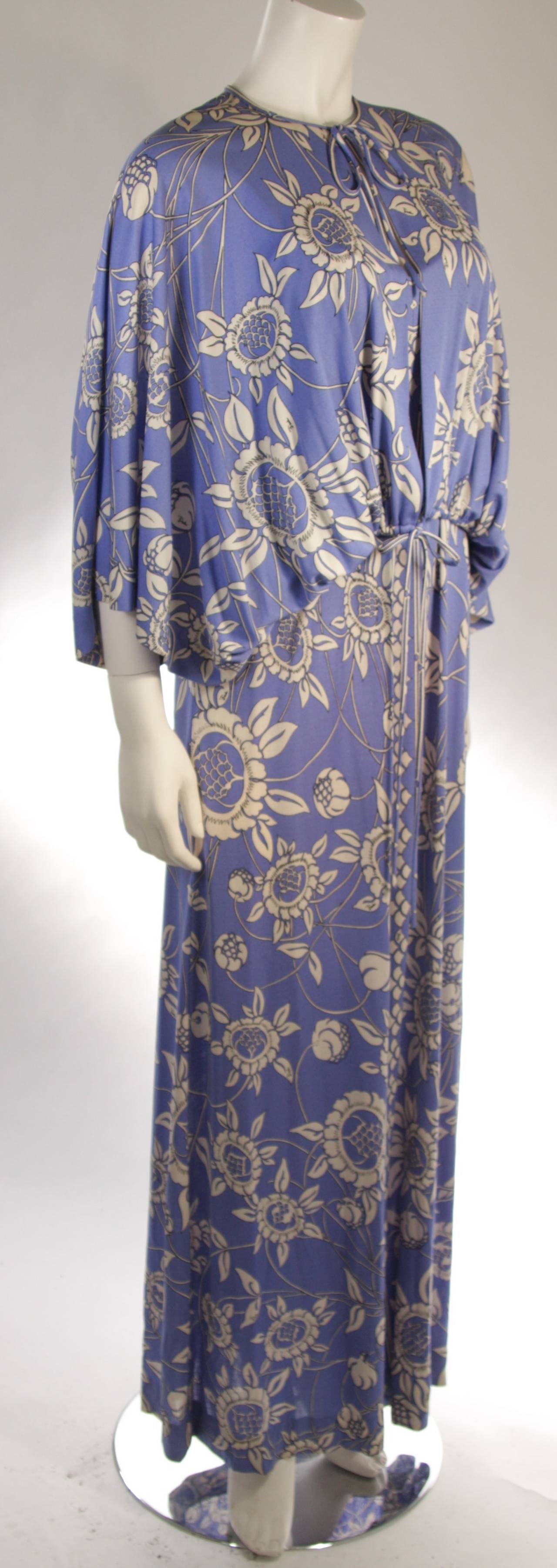 This fabulous Pucci ensemble features a open style top with a tie closure and a strap style full length dress. The fabric is a lightweight periwinkle hued jersey with a floral Pucci patterned motif. Made in Italy.

Measures (Approximately)
Size