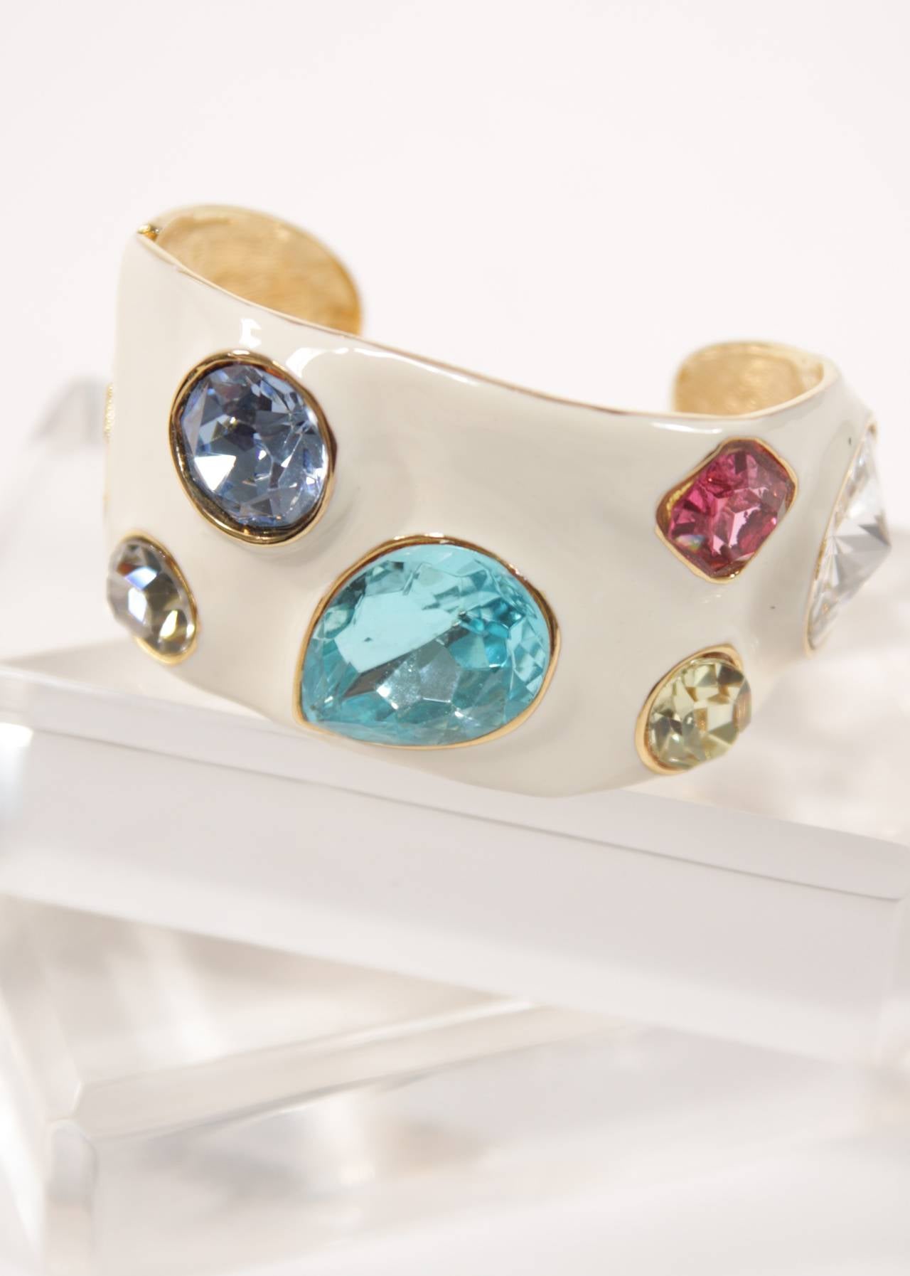 This fabulous Kenneth Lane bracelet is composed of enamel and set with large rhinestones. Features a hinged opening. Measures 1.5