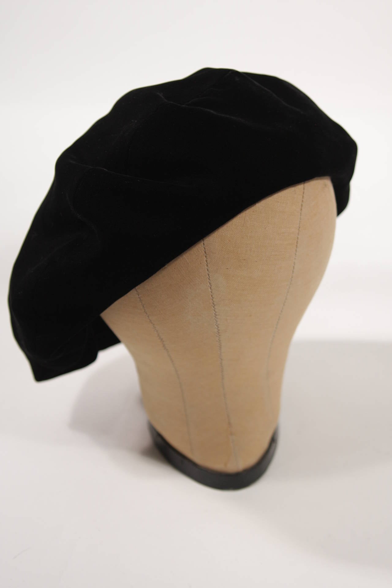 This Yves Saint Laurent hat is available for viewing at our Beverly Hills Boutique. Composed of black velvet. Made in France. 

Measures (Approximately)
Size 59
Circumference: 22. 53