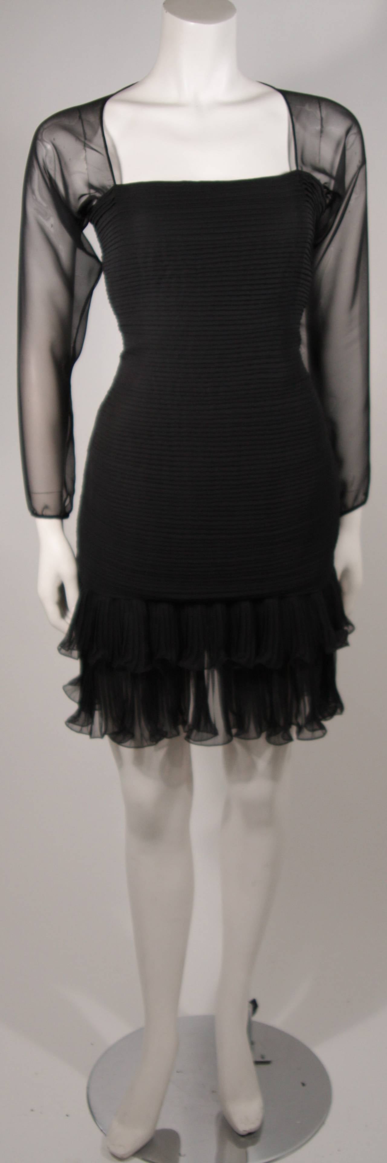 This Oscar De La Renta cocktail dress is composed of a black silk chiffon. The design features sheer sleeves, a pleated bodice, and ruffled hem . There is a zipper closure for ease of access. 

Measures (Approximately)
Size 10
Length:
