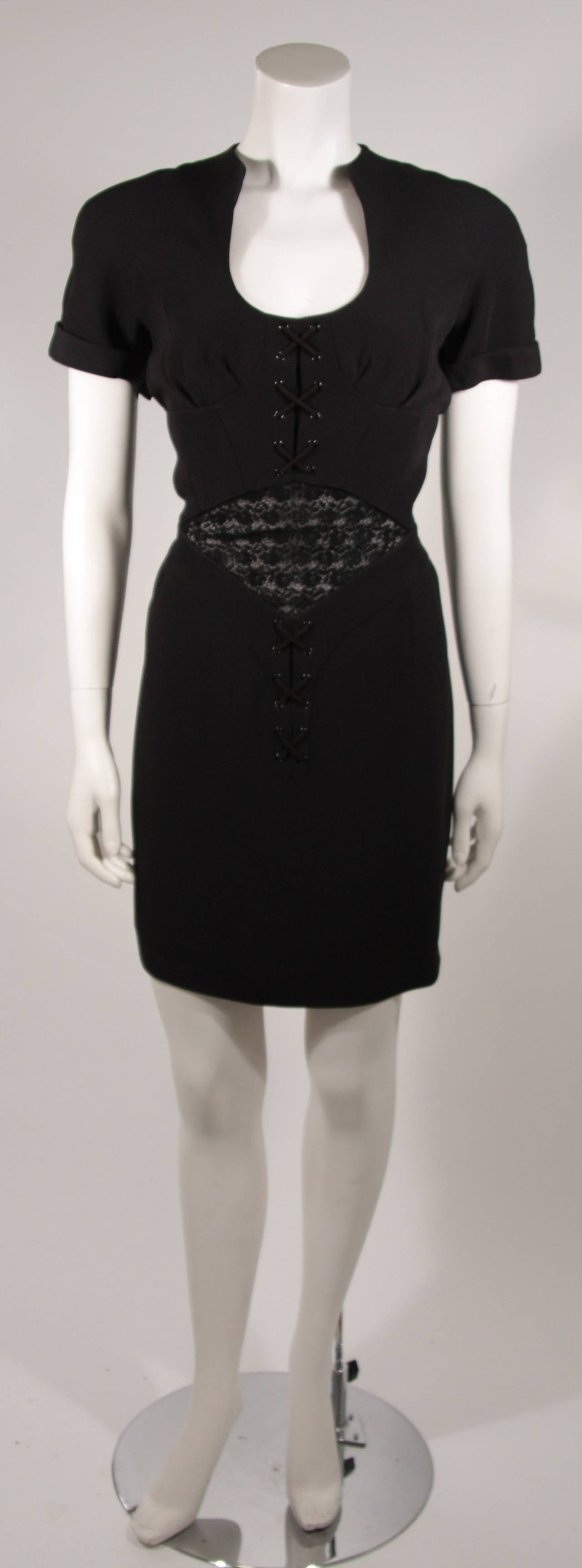 This Theirry Mugler dress is composed of a black fabric which is accented by a lace mesh insert  at the waist and center front corset detailing. Center back zipper closure. Made in France. 

Measures (Approximately)
Size 40 
Length:
