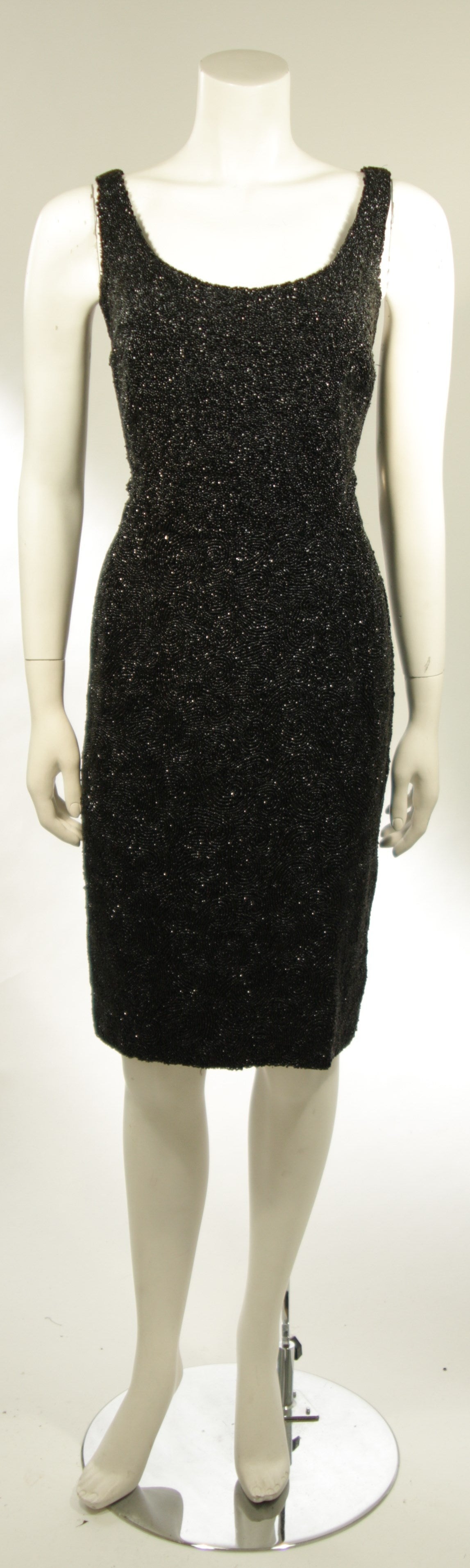 This spectacular cocktail dress is circa 1960's and is beautifully beaded. There is a center back zipper. Excellent condition. 

Measures (Approximately)
Length: 40.5