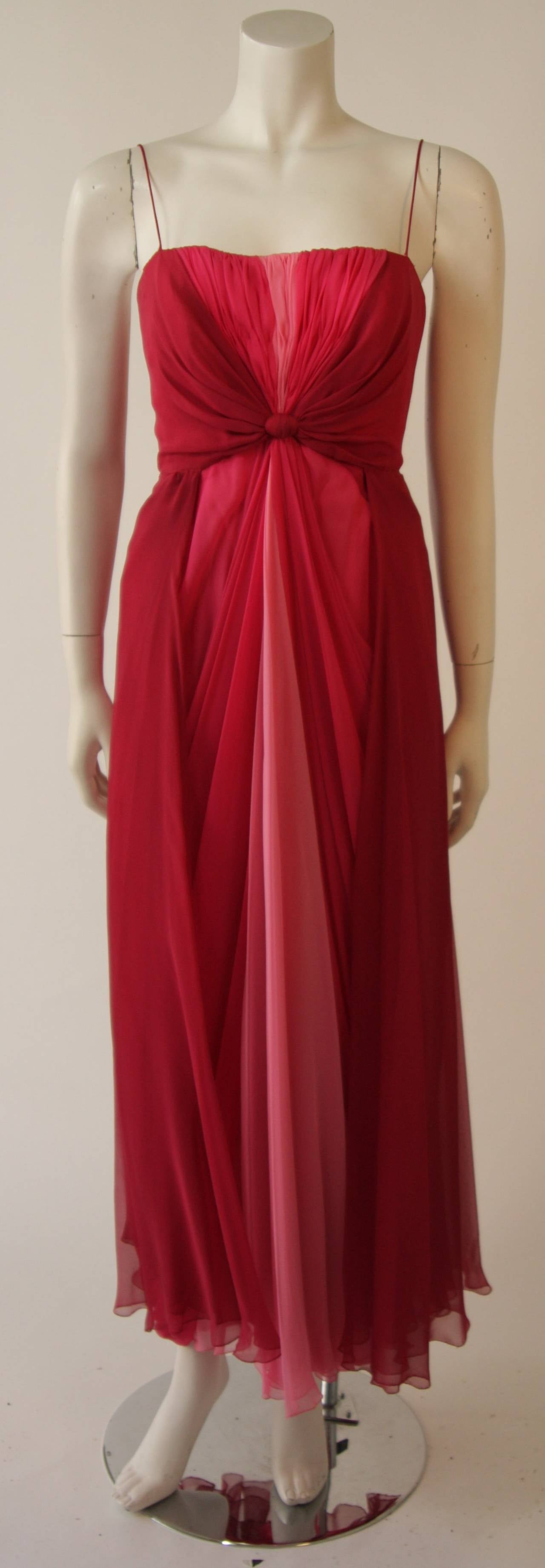 This Myer Kahan gown is composed of a silk chiffon in rose and pink hues. Features an empire waist which drapes at into the skirt creating a gorgeous goddess silhouette. There is a zipper back closure. 

Measures (Approximately)
Length: 48