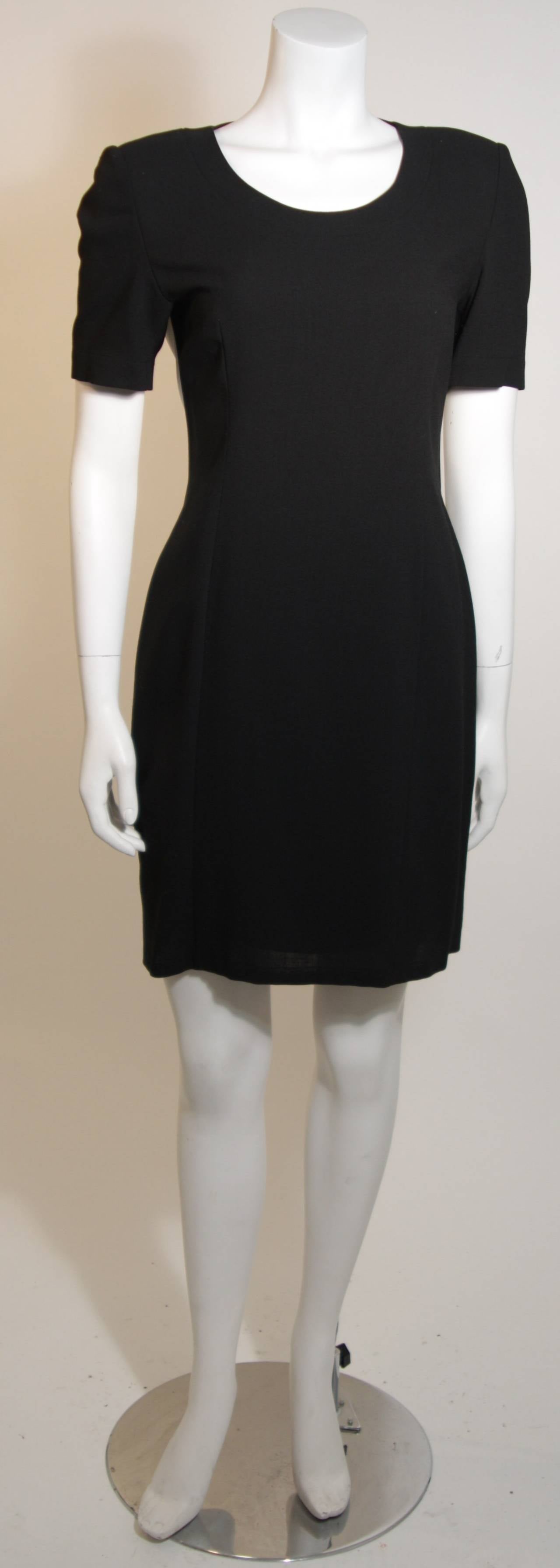 This Gianfranco Ferre dress features a side zipper. The black and white back is complimented by a embossed leather suspender detail. Made in Italy. 

Measures (Approximately)
Size 40 
Length: 35.5