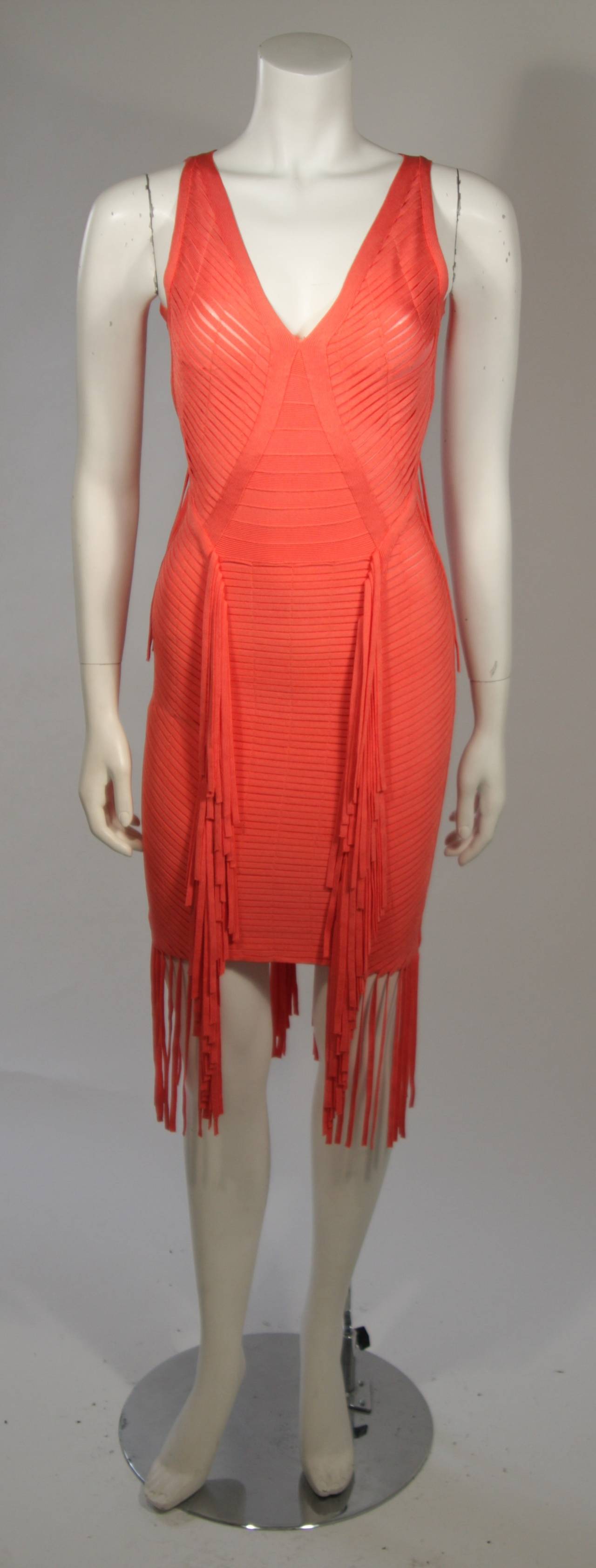 This Herve Leger body contouring dress is accentuated by a fringed detail. There is a center back zipper. 

Measures (Approximately)
Size XS
Length: 33