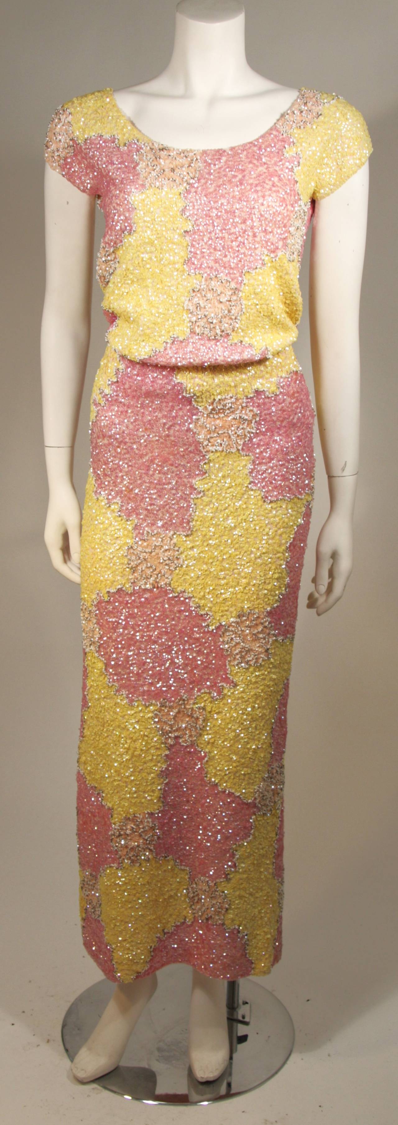 This lovely skirt set is composed of a stretch knit wool adorned with pink and yellow sequins. The top features a center back zipper. 

Measures (Approximately)
Top
Length: 16