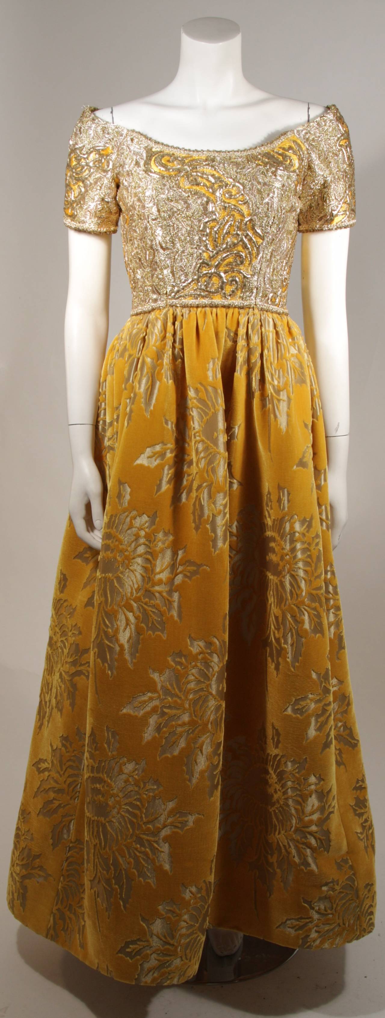 This Oscar De La Renta Couture design is available for viewing at our Beverly Hills Boutique. We offer a large selection of evening gowns and luxury garments.

This gown is composed of gold and mustard hues in embellished silk and mustard yellow