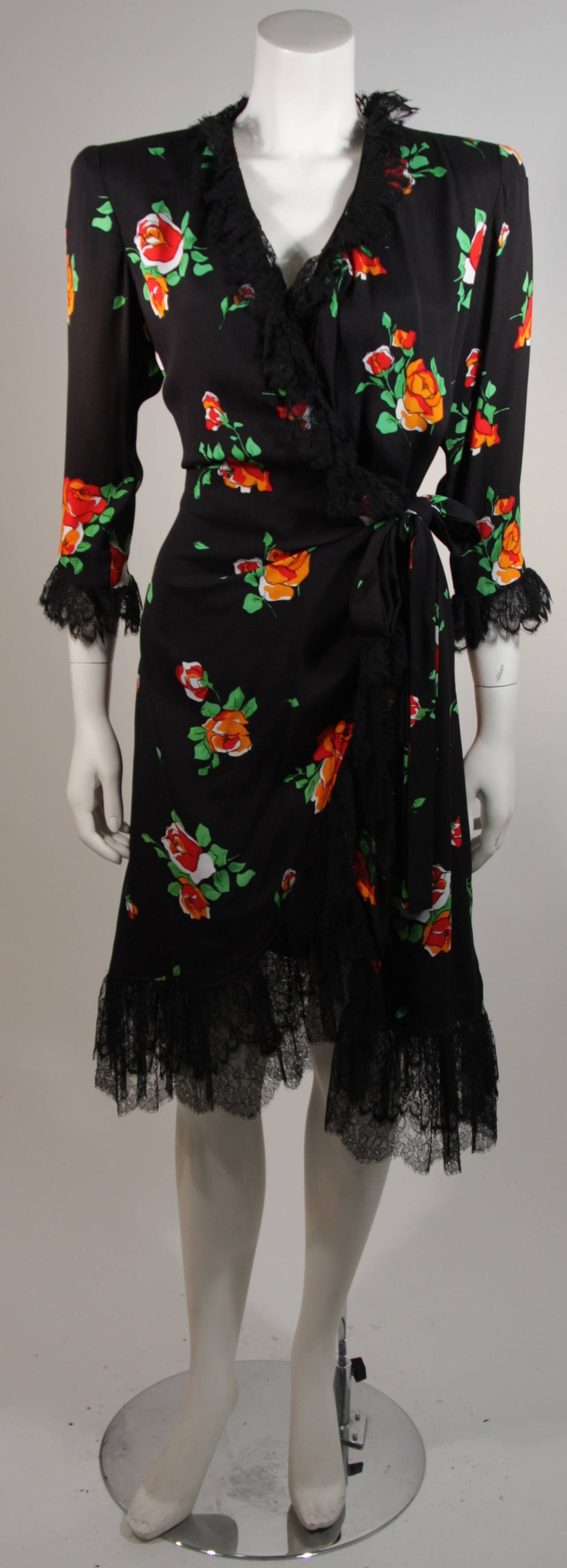 This Yves Saint Laurent dress is available for viewing at our Beverly Hills Boutique. We offer a large selection of evening gowns and luxury garments.
This vintage wrap dress is composed of black crepe with a deep orange rose print, lined in black