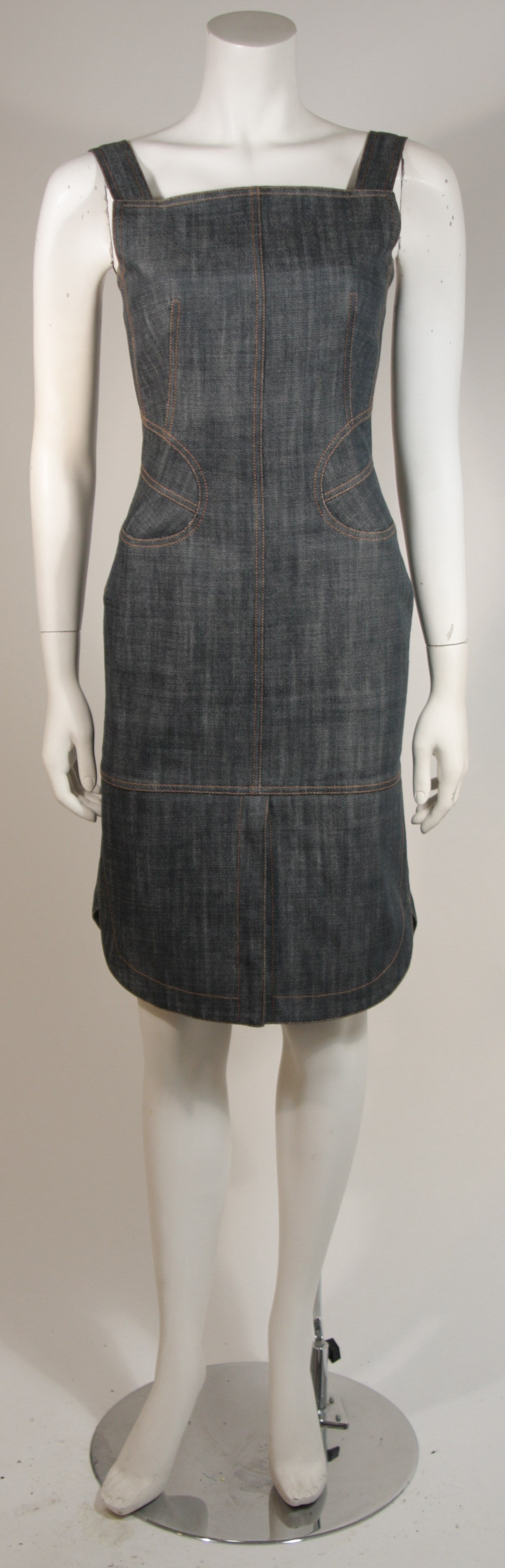 This Alaia dress is composed of denim and designed with a flare fit at the back skirt. There is a center back zipper for ease of access.  An embossed extension has been added at the upper back. 

Measures (Approximately)
Length: 35